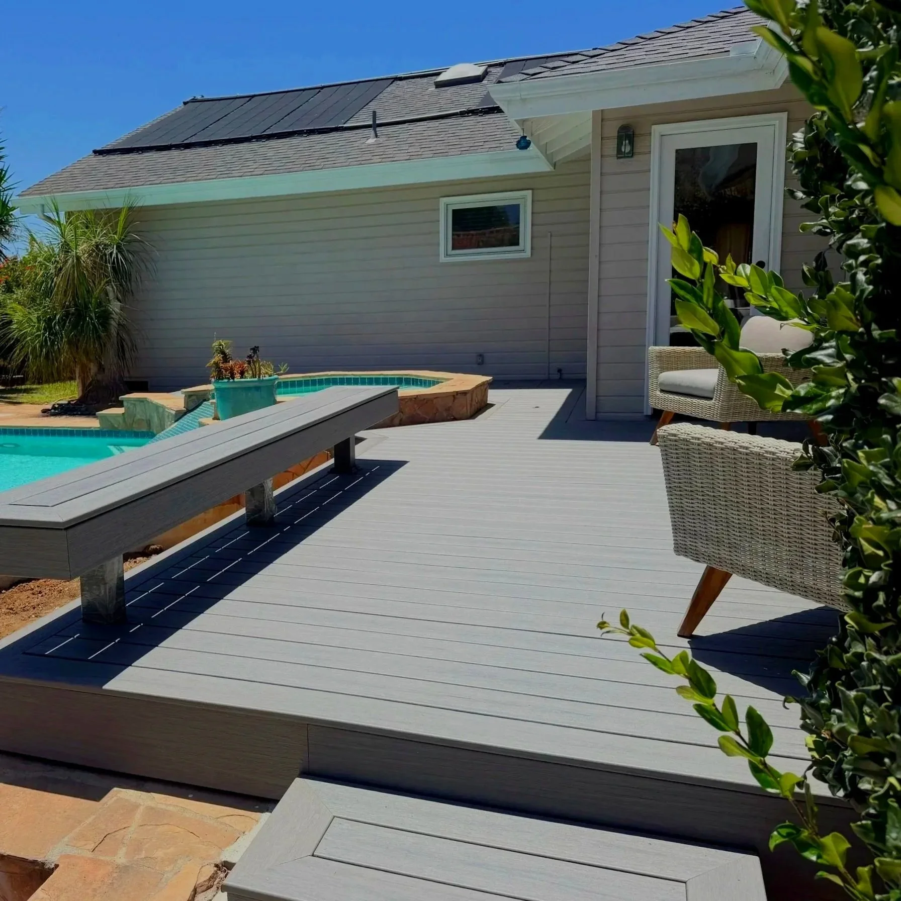 Custom Trex poolside deck with built-in bench in Encinitas, CA.