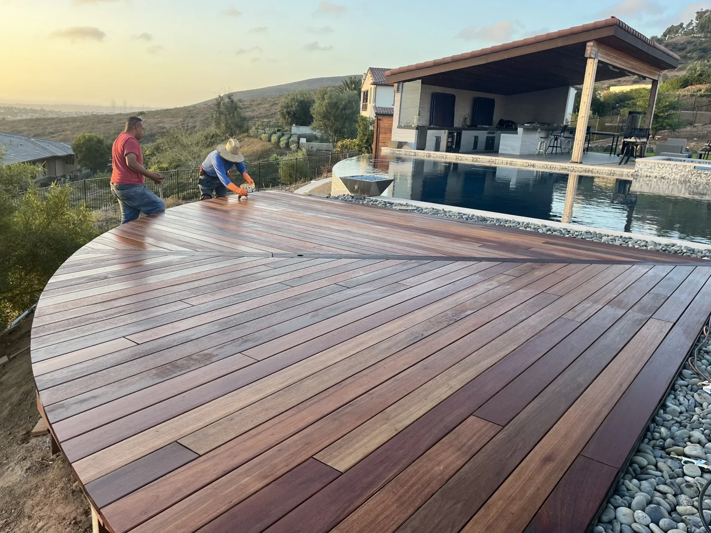 Custom curved Mangaris wood deck with poolside design in Rancho Santa Fe, CA.