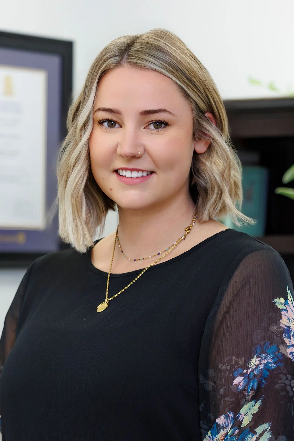 Image of Elyse Kettle. She has blonde wavy hair and is smiling.