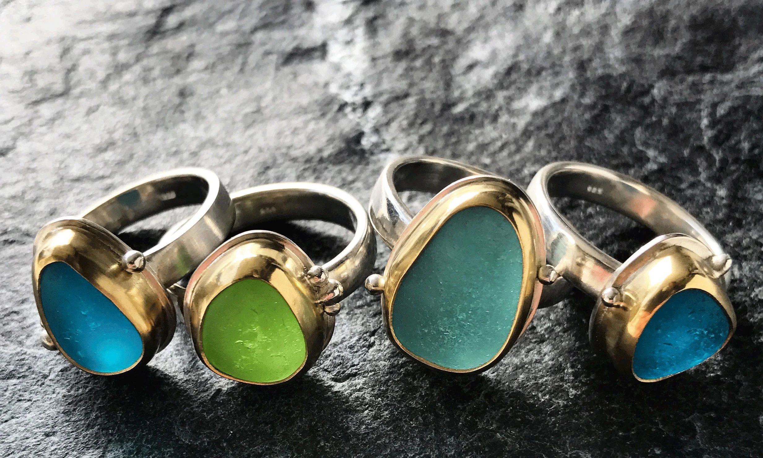 Sea glass rings made with silver and gold by Monica Cardone