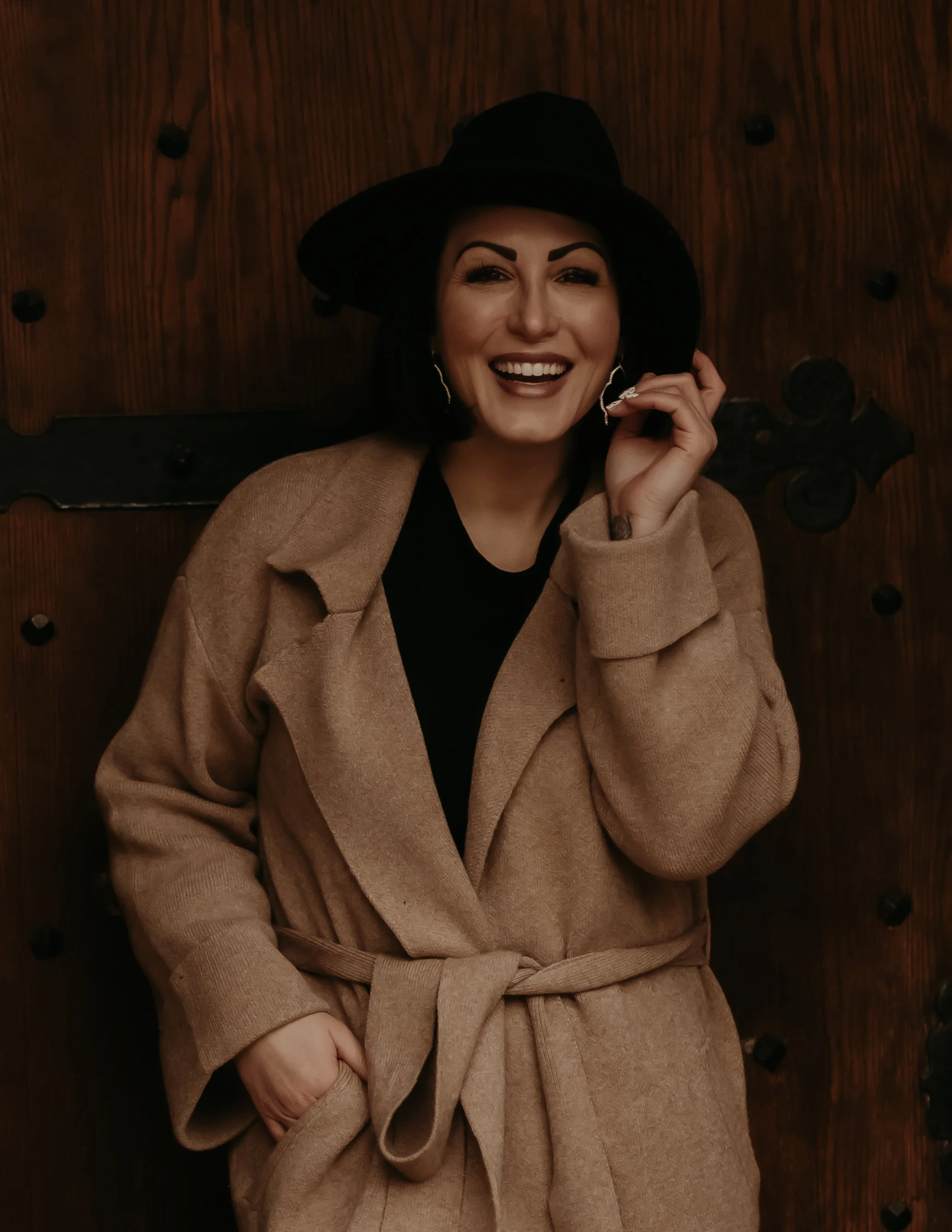 Woman laughing outdoors in Wichita, Kansas, captured in a candid, moody, and authentic photography session by an affordable local photographer