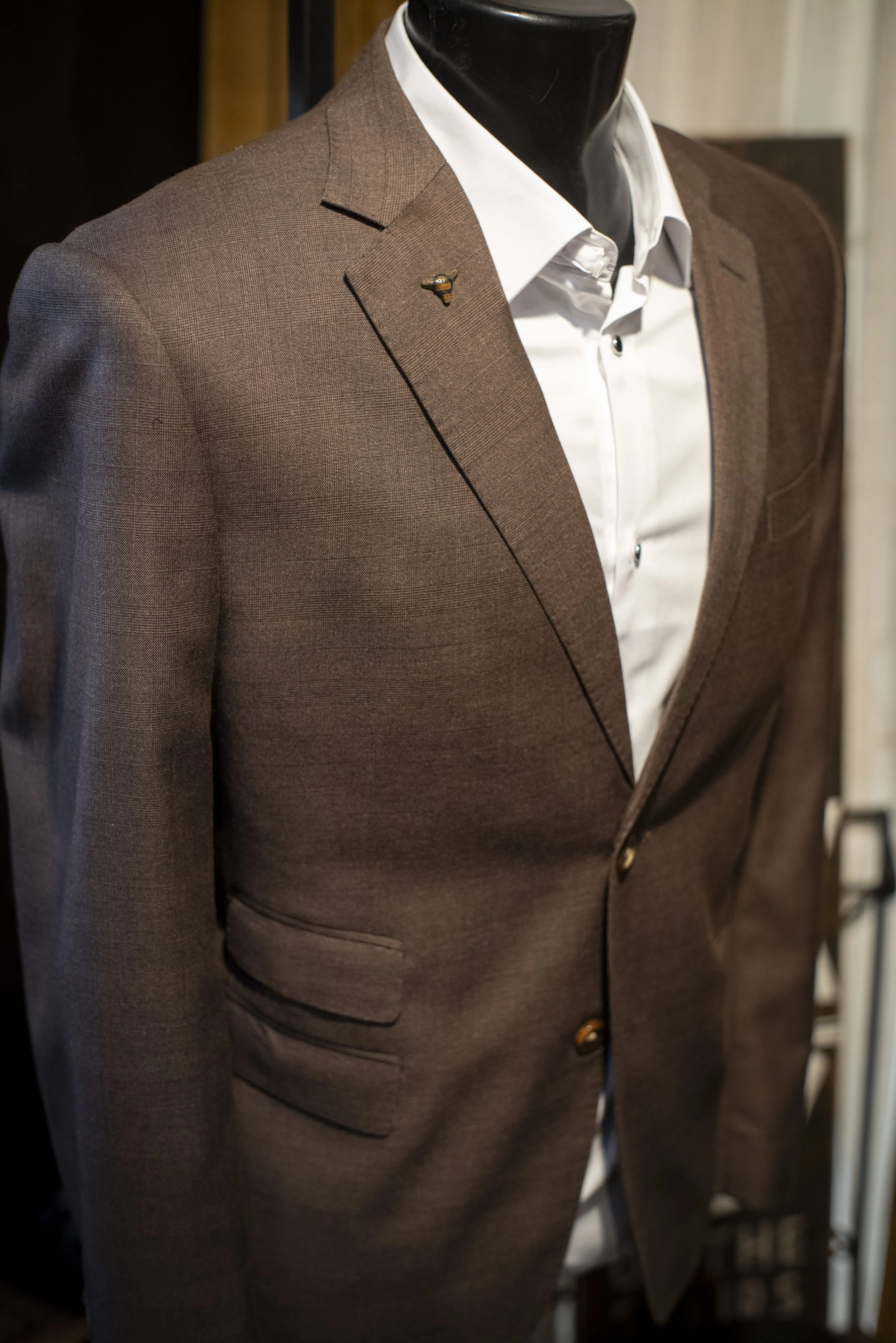 Custom suit in Tampa, Florida - brown with custom shark tooth accessory.