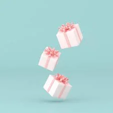 Three white gift boxes with pink ribbons floating against a light blue background.