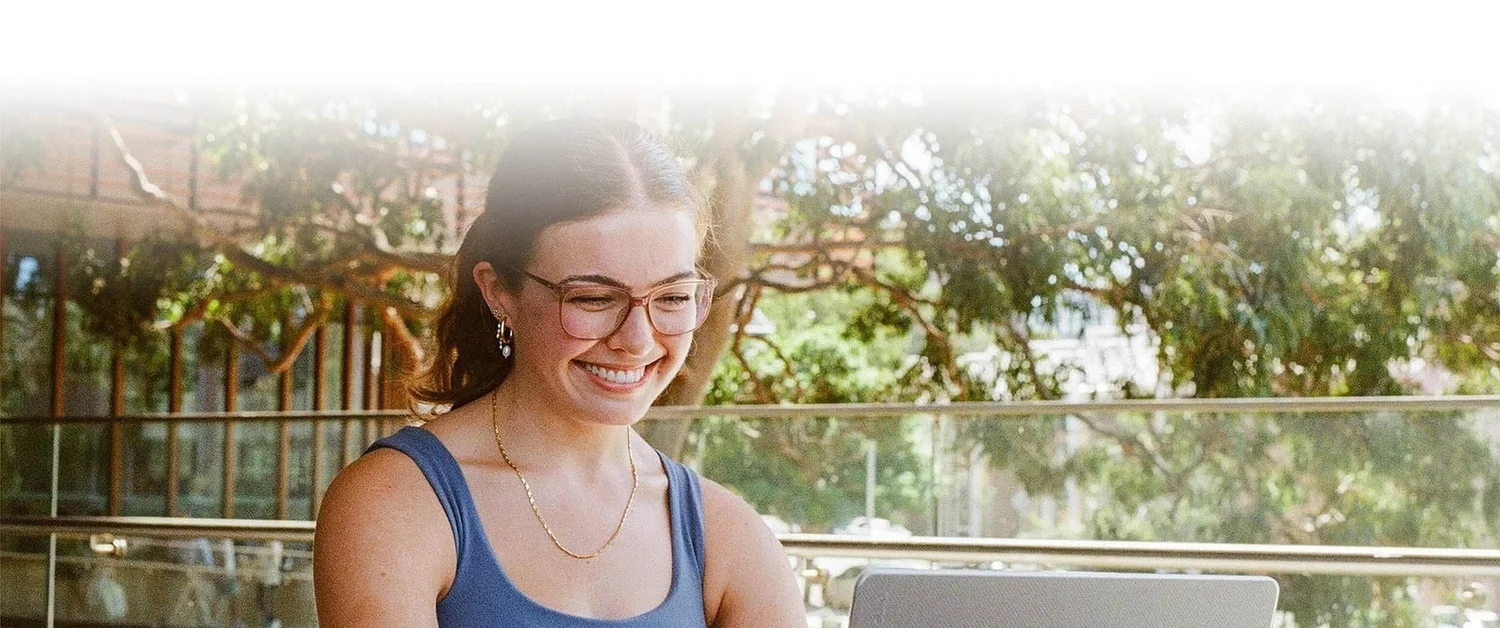 IB student studying outdoors on a laptop