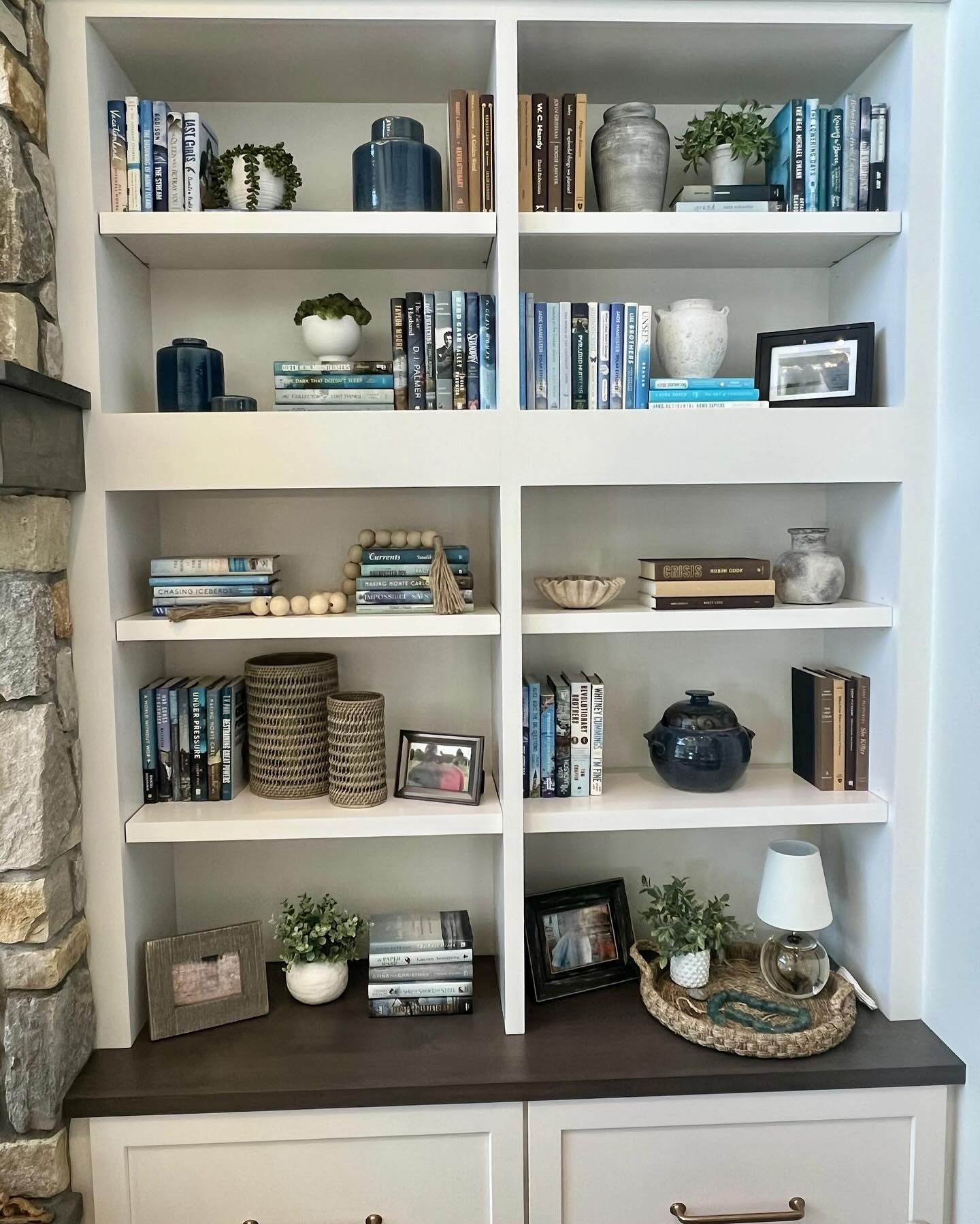 Bookshelf styling can completely transform a space. By blending texture, balance and personality, we transformed this once cluttered display into a curated masterpiece! 

#nestindesign #nestofgrandtraverse #bookshelfstyling #interiorstyling #homedeco