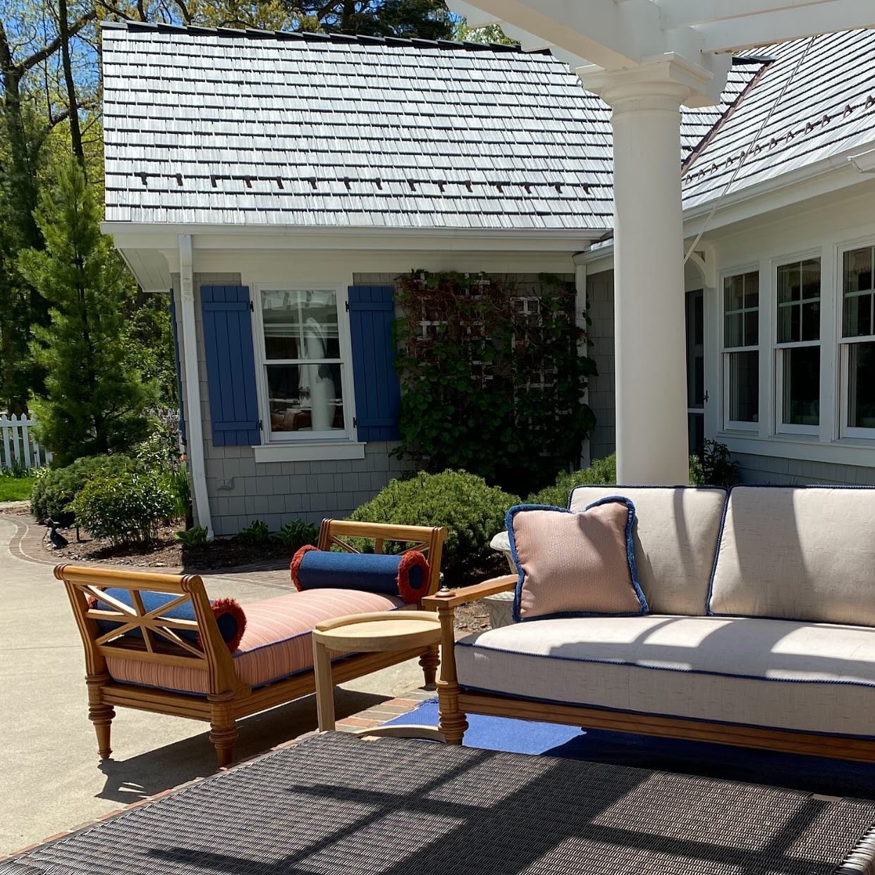 Another stunning outdoor space we designed, custom fabrics and outdoor area rug all coordinate with the new paint colors and shutters we selected for this project. Note the custom mix on the shutters of Benjamin Moore&rsquo;s Indi Go-Go, where we tin