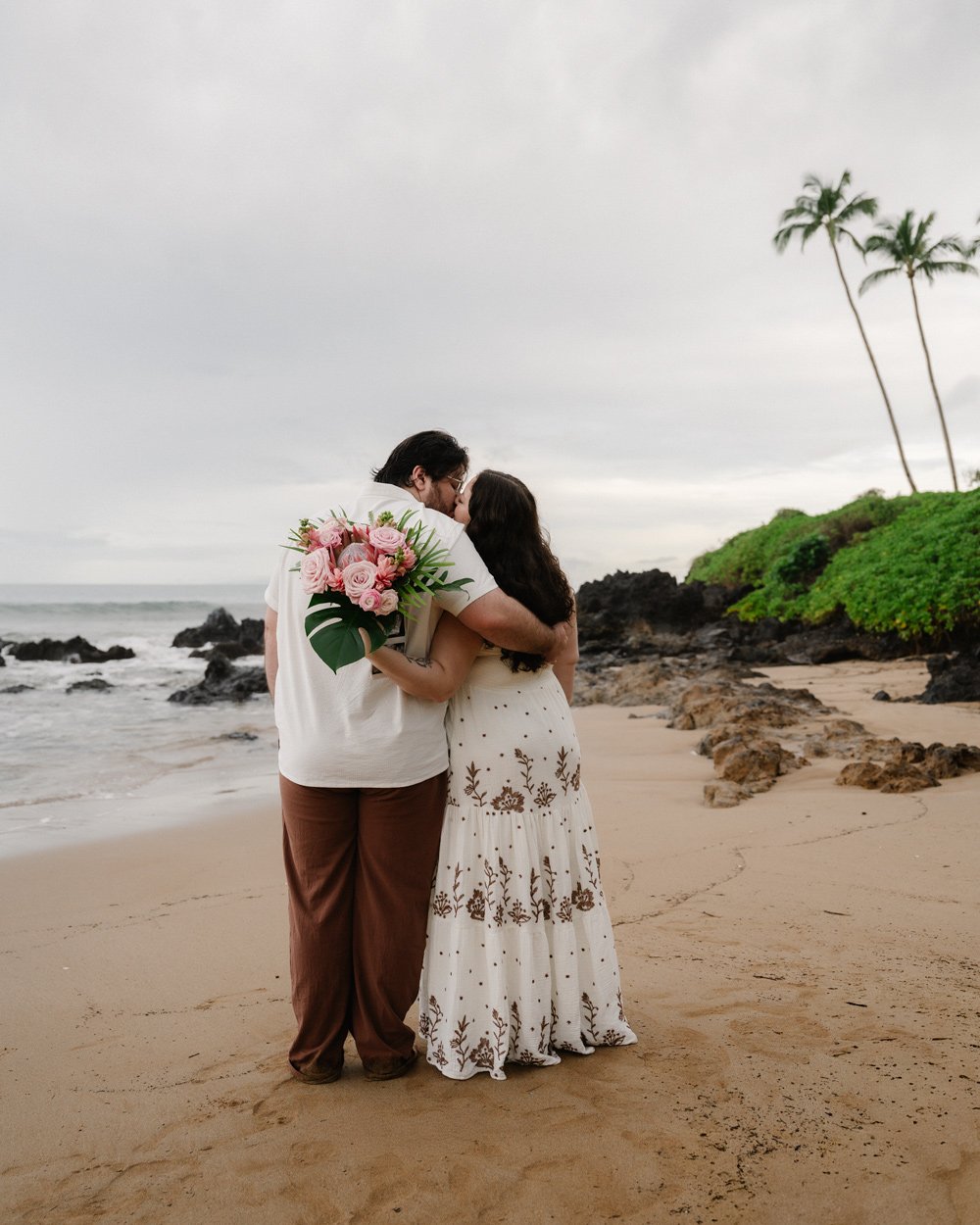 Gender reveal at Maui beach with tropical Maui flowers