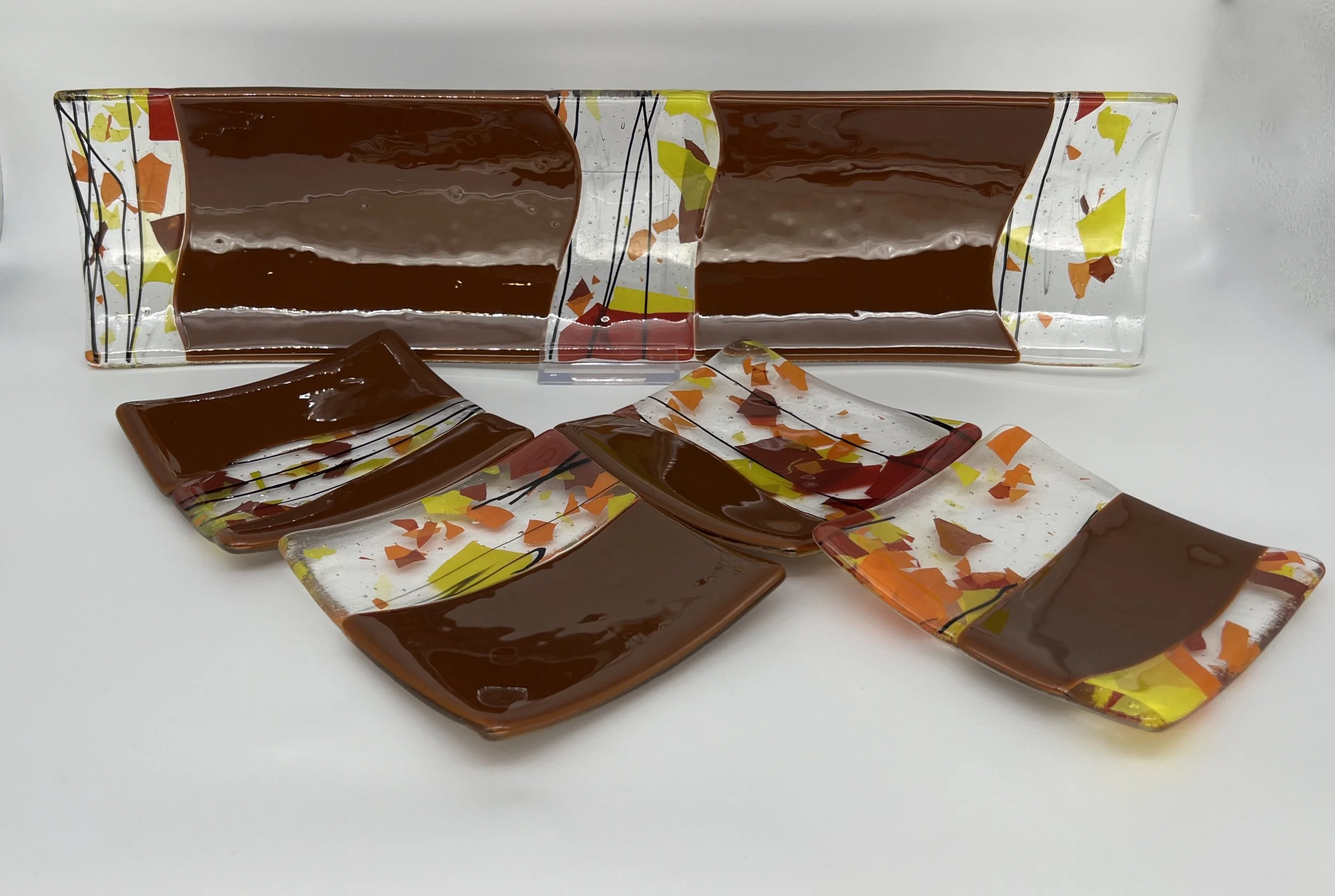 5 piece set  Channel platter is 17" x 4.5". Appetizer plates are 4.5" square.  Cinnabar with Autumn Confetti Insets. $135/ set