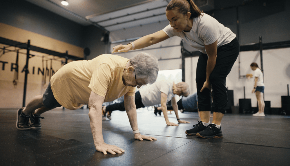 A York County Training coach supporting a member during a group class