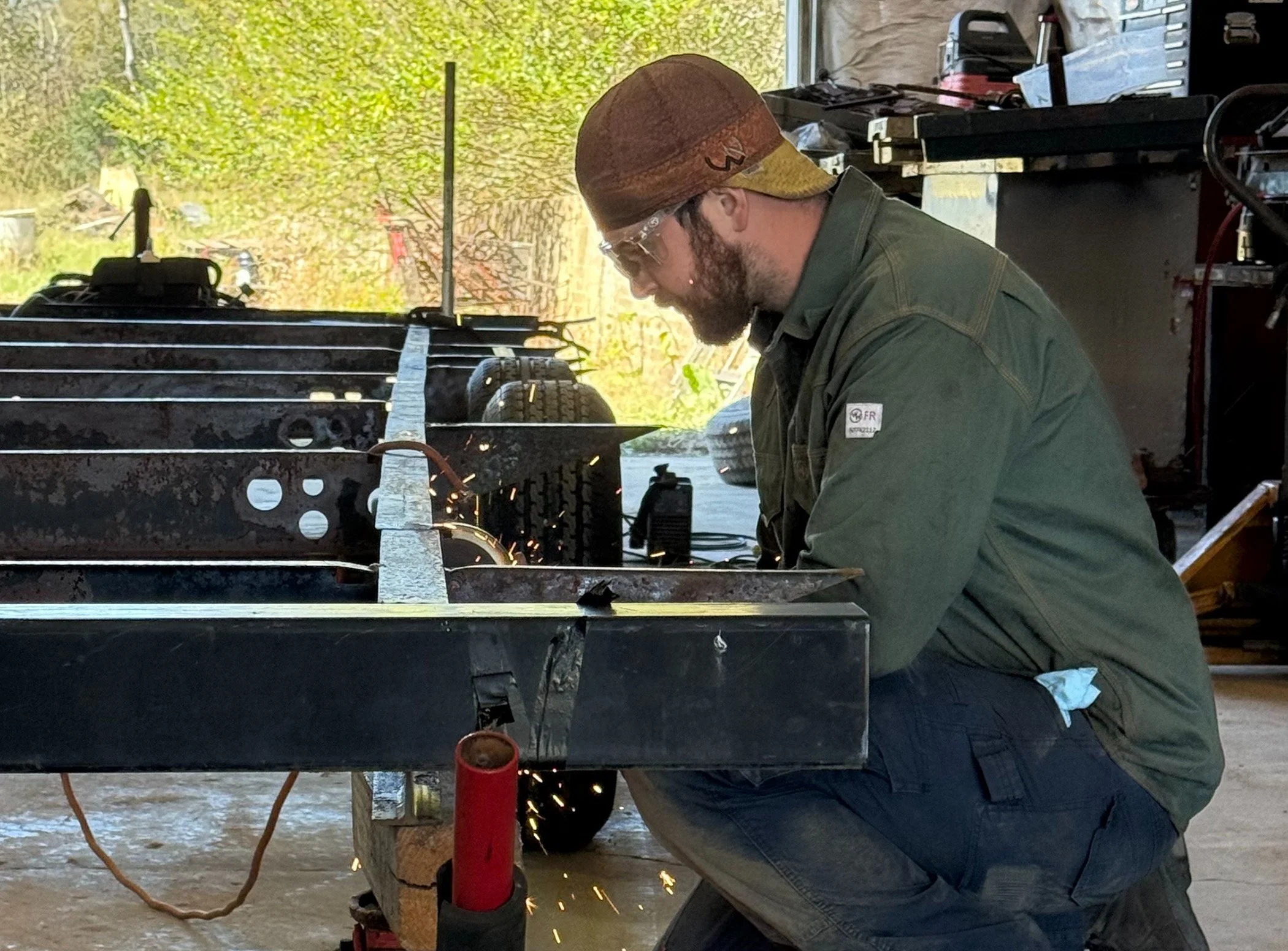 T5 Plus Welding blacksmith working on structural repairs to a trailer