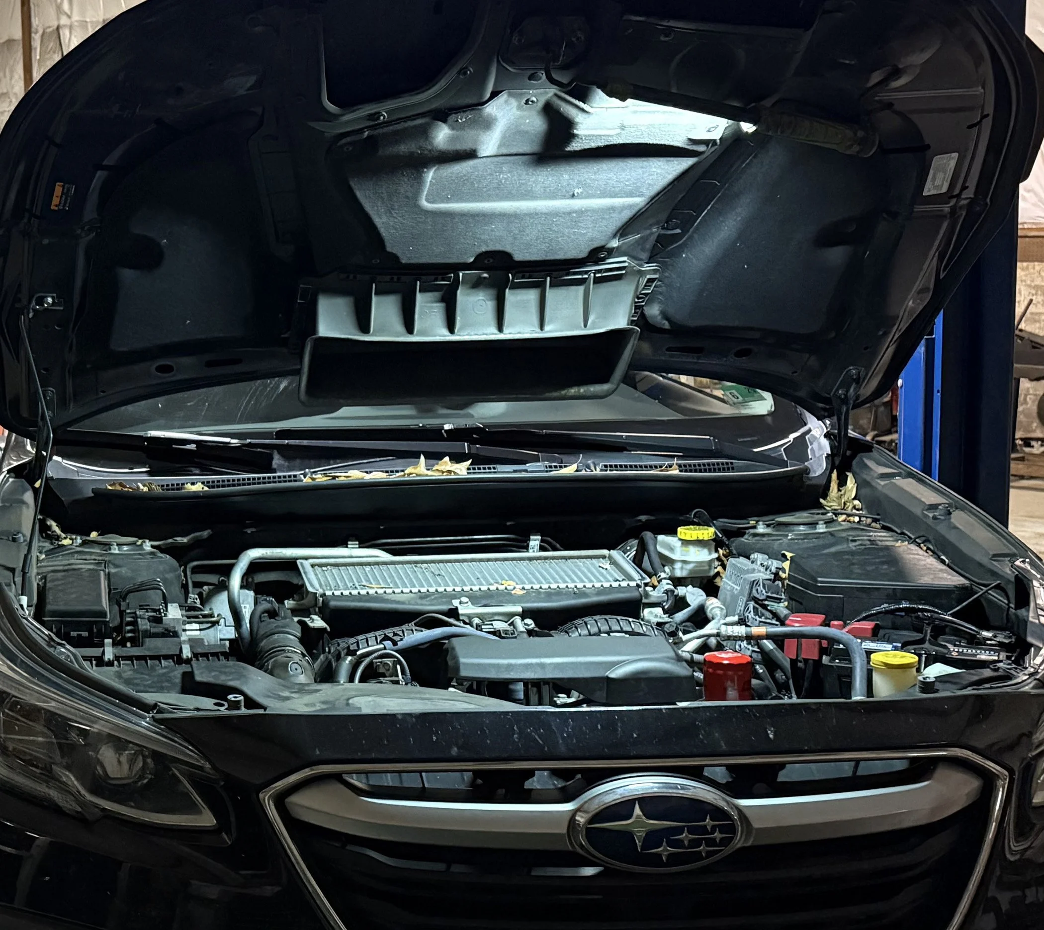 Image of a car's hood up while having general repairs and service in the T5 Plus Auto Repair shop