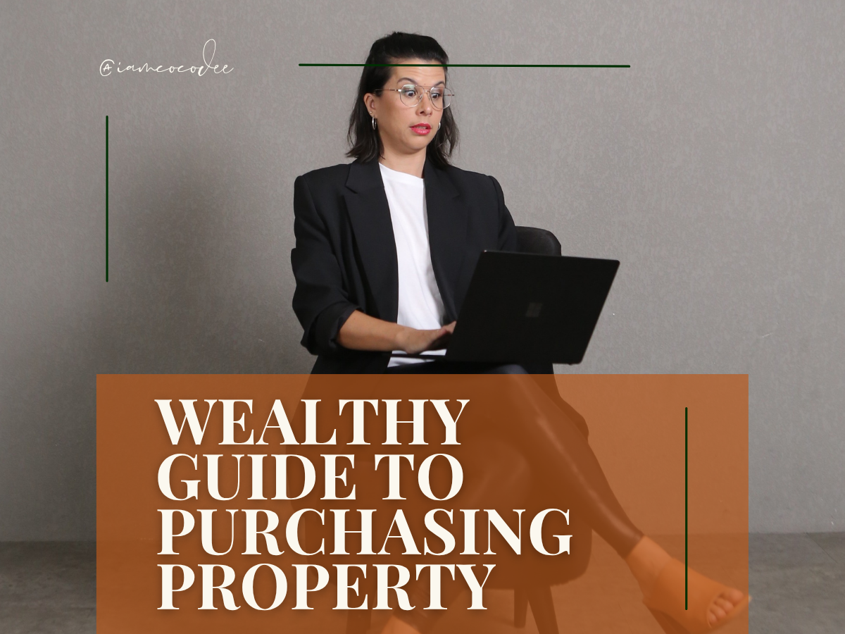 Woman in black blazer and white shirt sitting on a chair with a laptop, in front of a plain wall. Text overlay reads "Wealthy Guide to Purchasing Property".