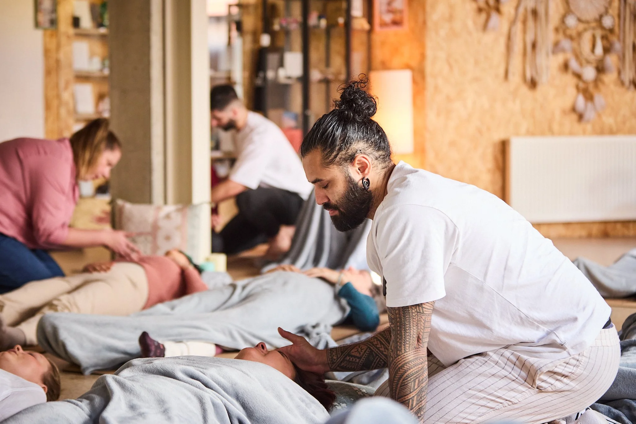 The master teaching team from Spinal Energetics: Pat Chirico, Heidi Marie and Jesse Akkerman guiding a course group through a gentle breathwork session as part of Level One.