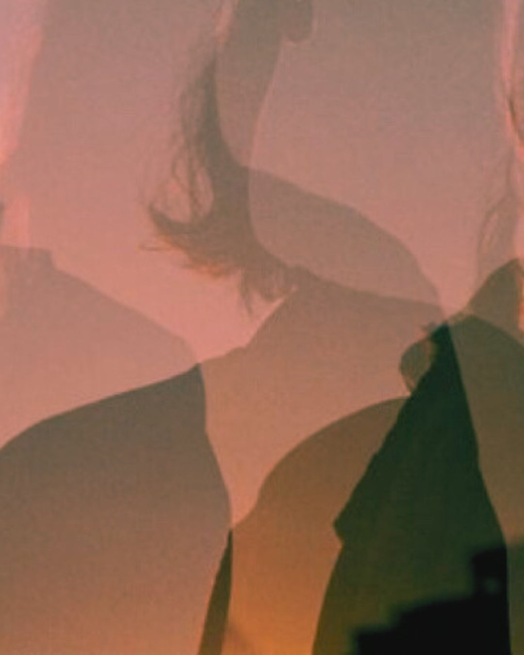 Close-up of a person's face and shoulder with soft lighting and shadows.