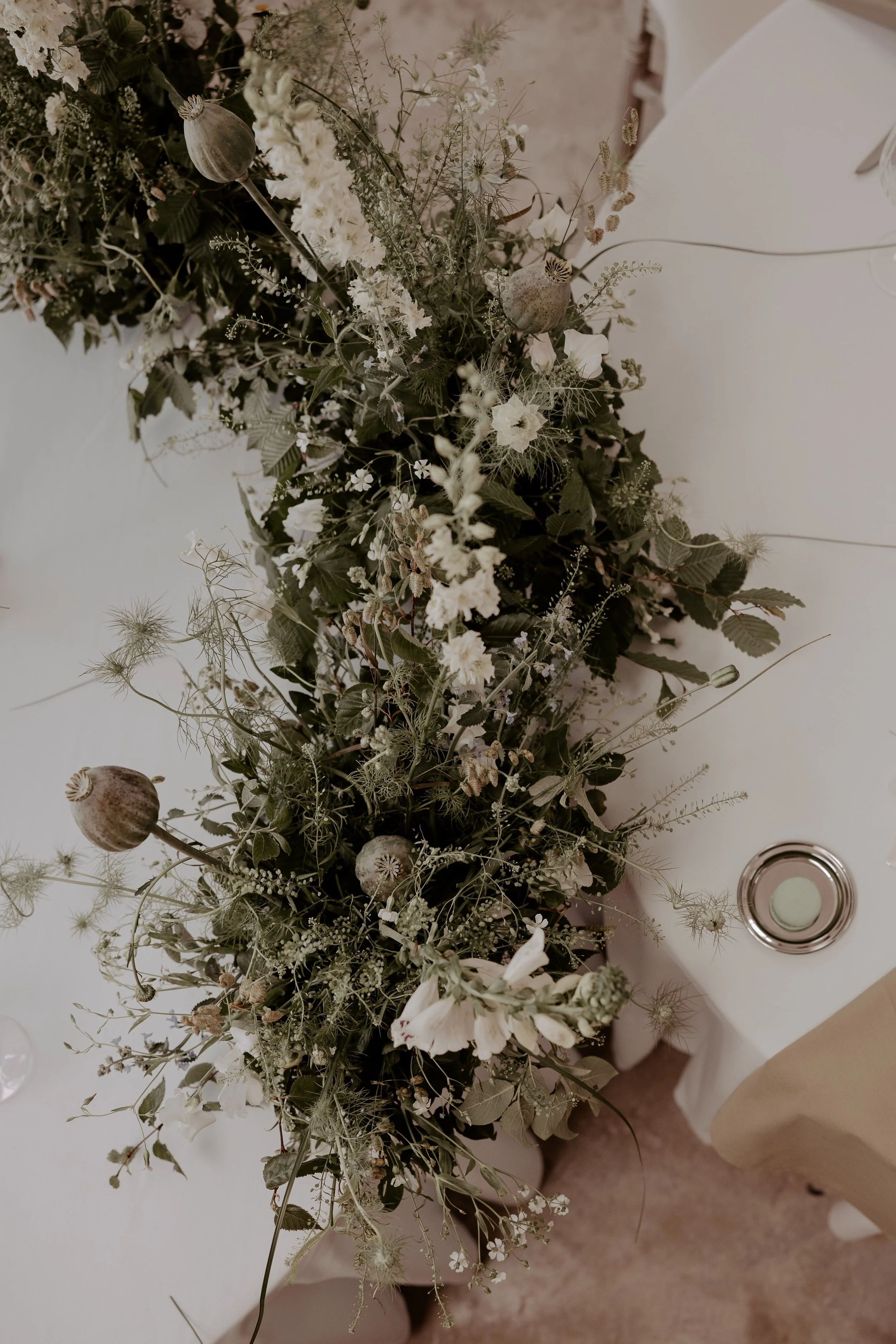 A modern and textural floral arrangement for a wedding tablescape by Darcey Floralscapes