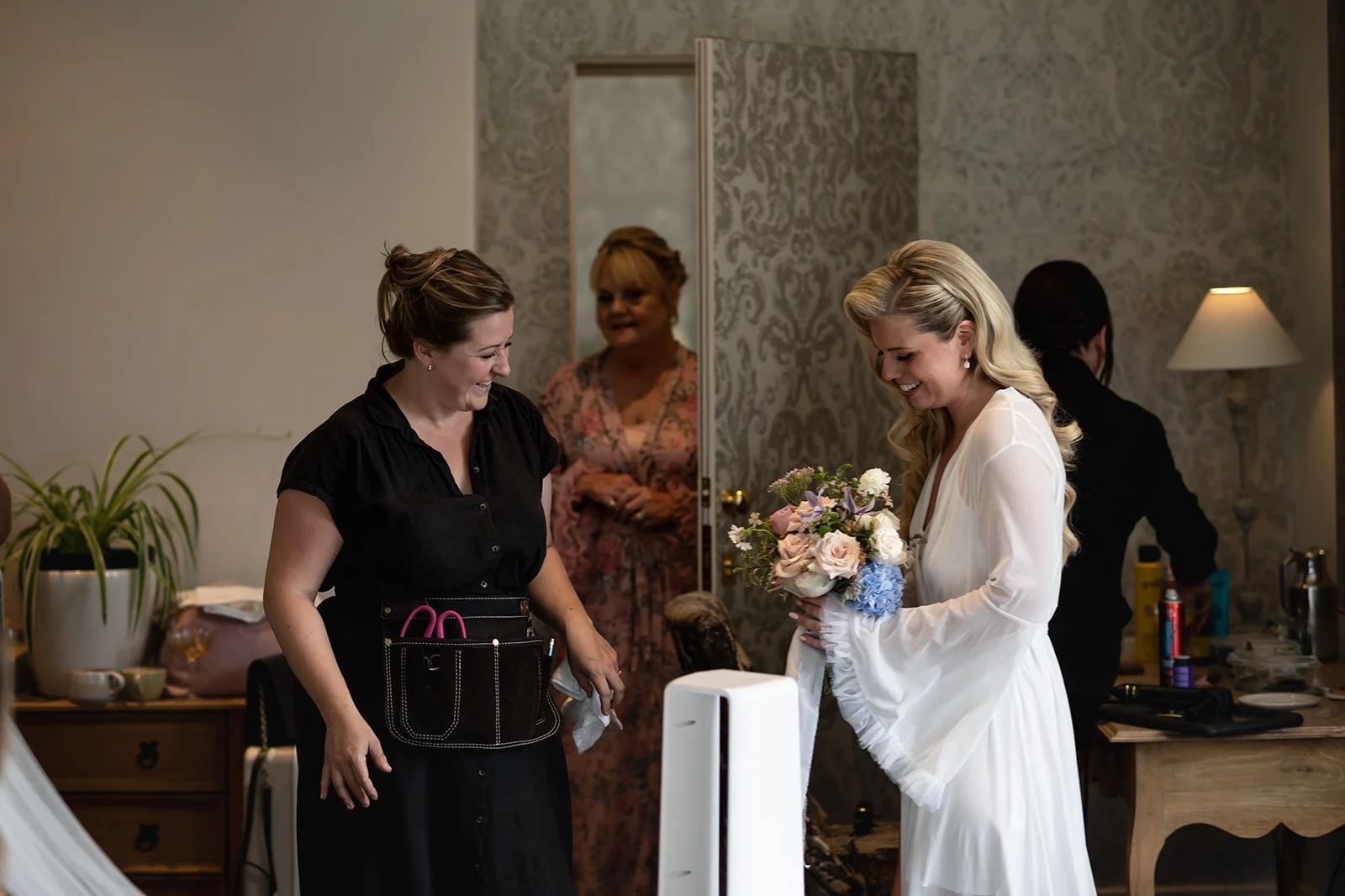 Handing the bridal bouquet, created by Darcey Floralscapes, to the bride. 