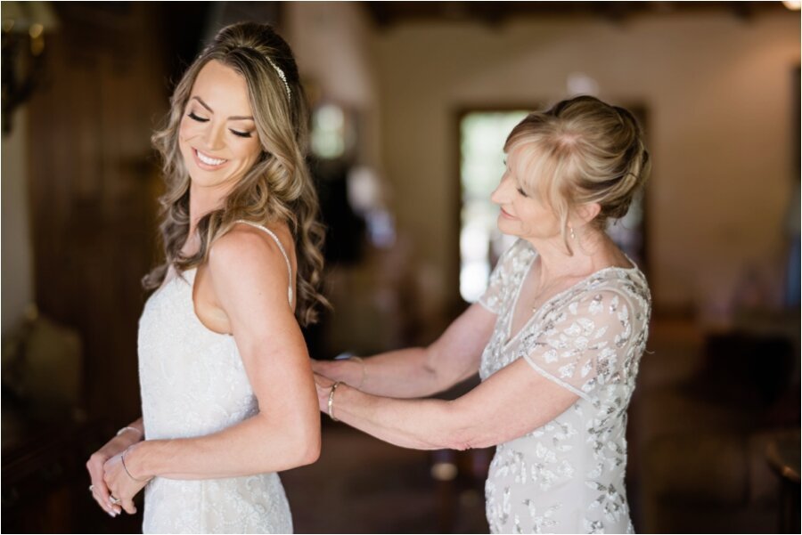 Epona Estate bride putting on her wedding gown