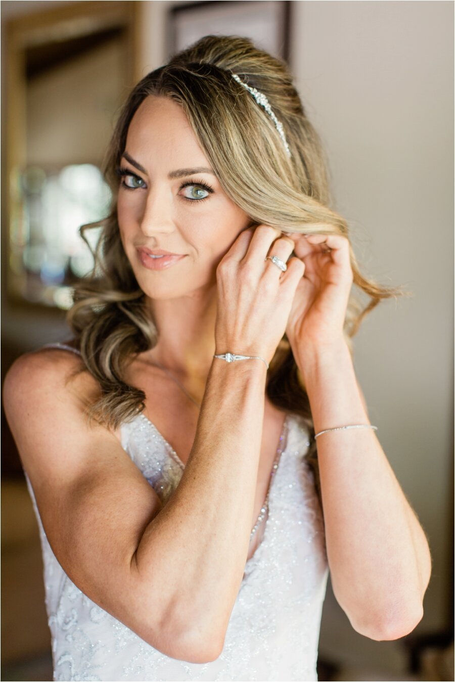 Bride puts on her earrings 