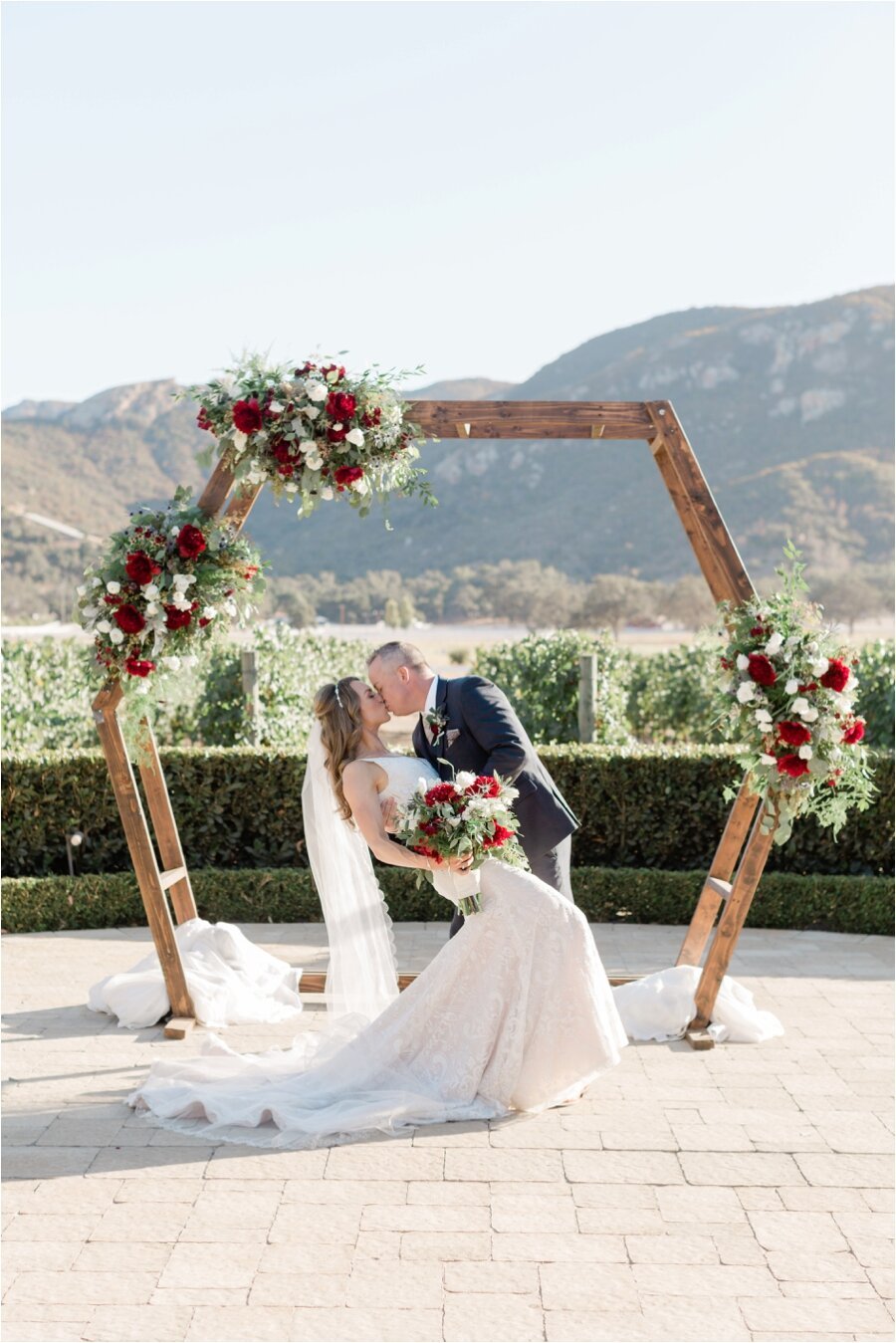 Bride and Groom pose under ceremony arch at Epona Estate Vineyard