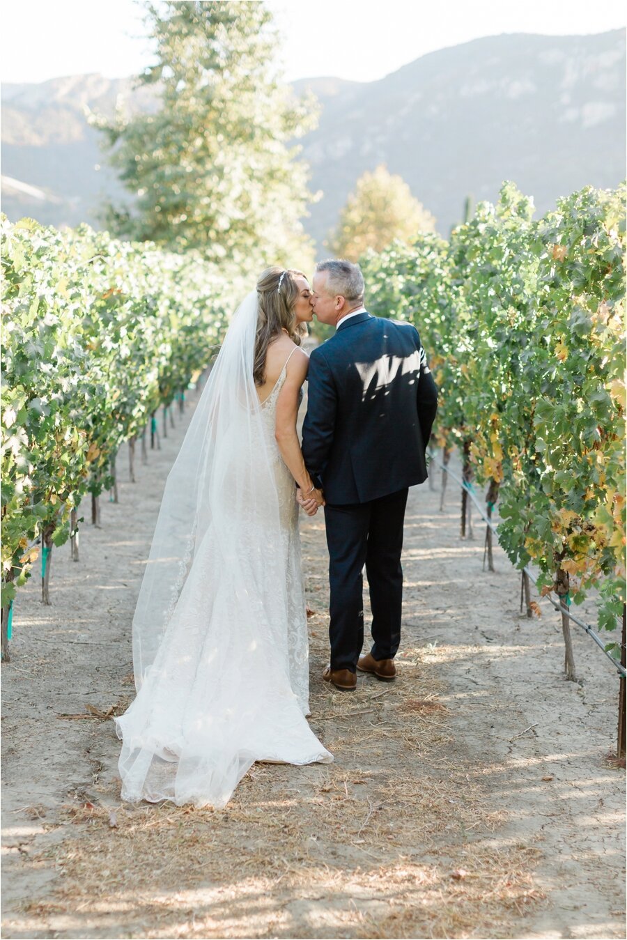 Bride and groom kiss in the Epona Estate Vineyard