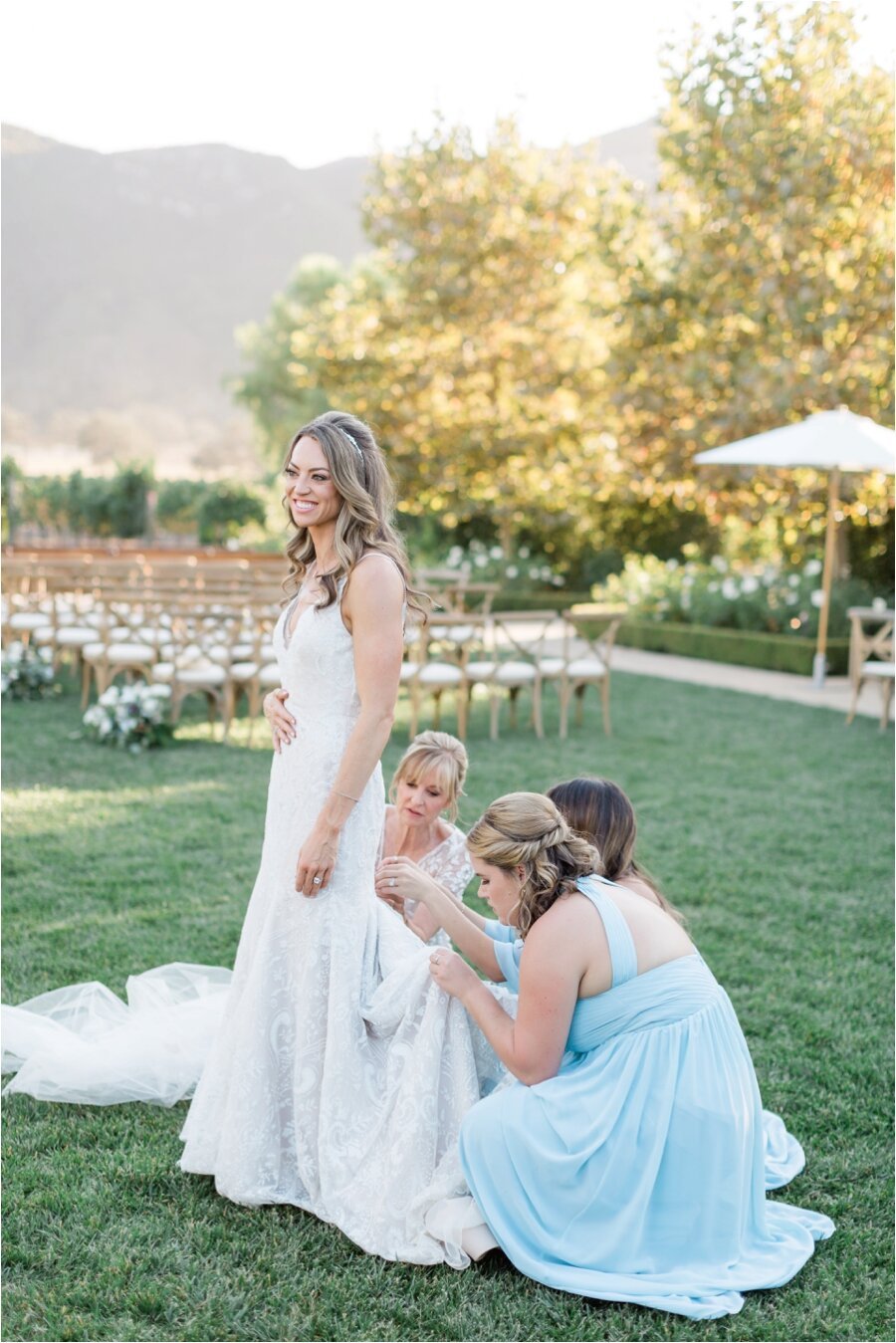 Candid moment of bride bustling her Hayley Paige wedding dress