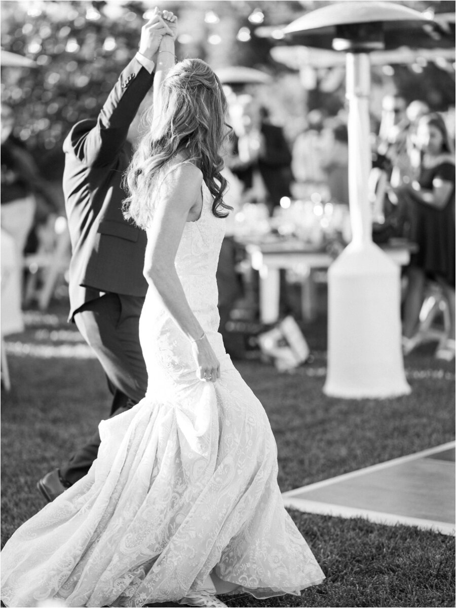 black and white candid of bride and groom grand entrance