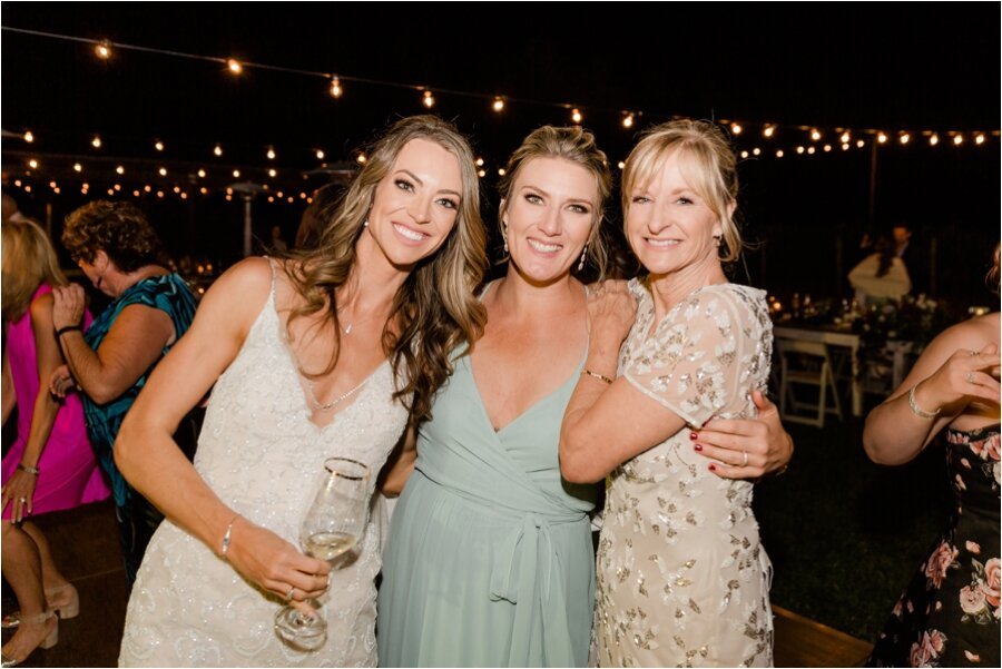 guests pose with bride on the dance floor