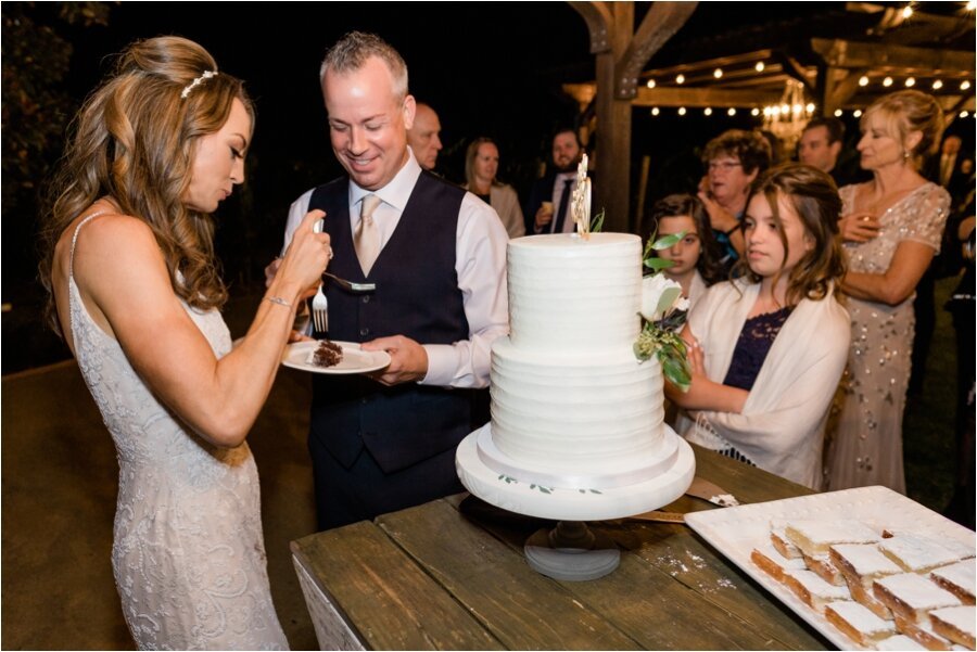 bride and groom enjoy their wedding cake