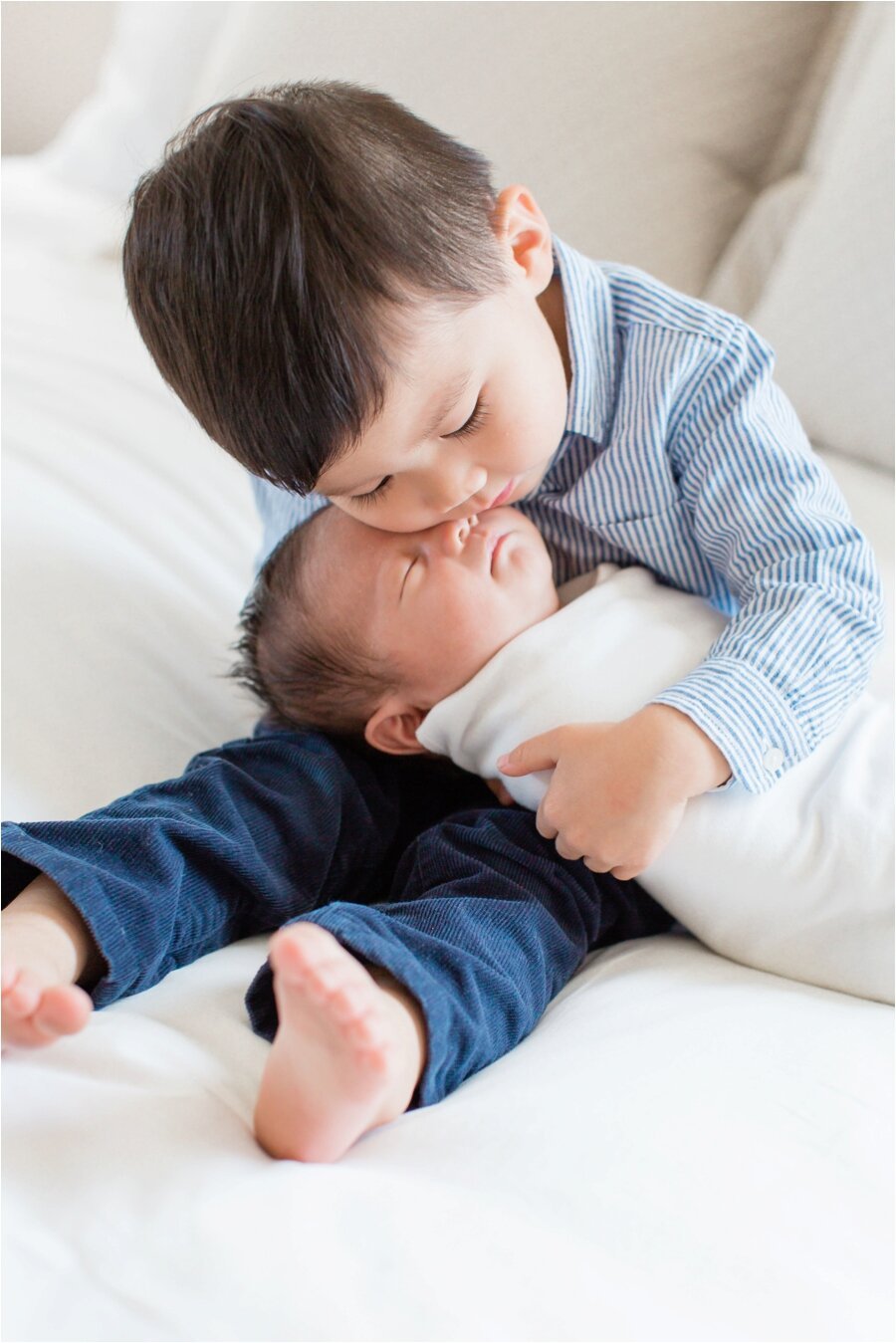 big brother snuggles his baby brother