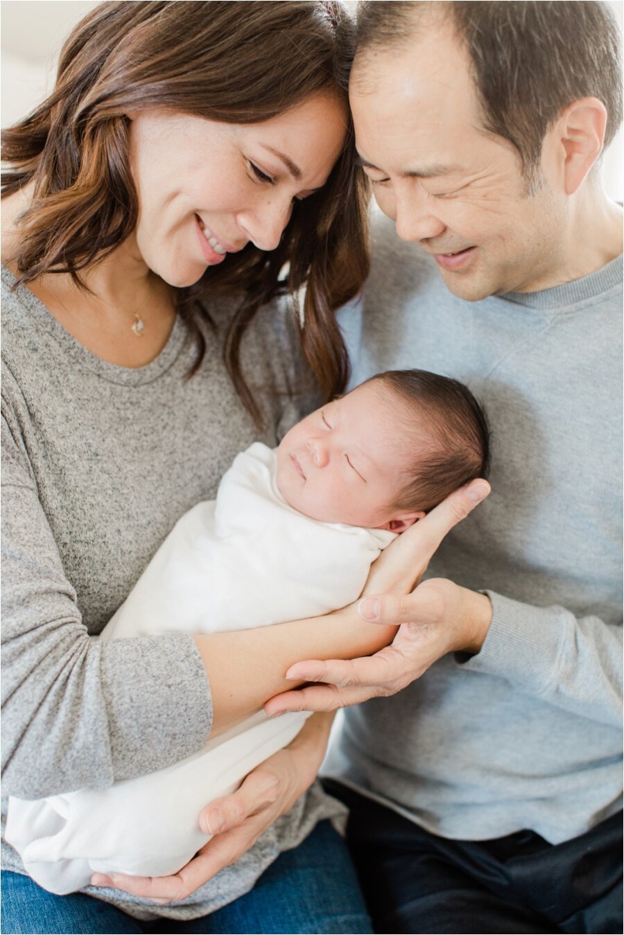 mom and dad pose with their newborn son