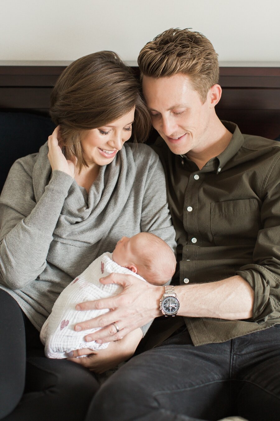 Portrait of mom and dad holding newborn baby