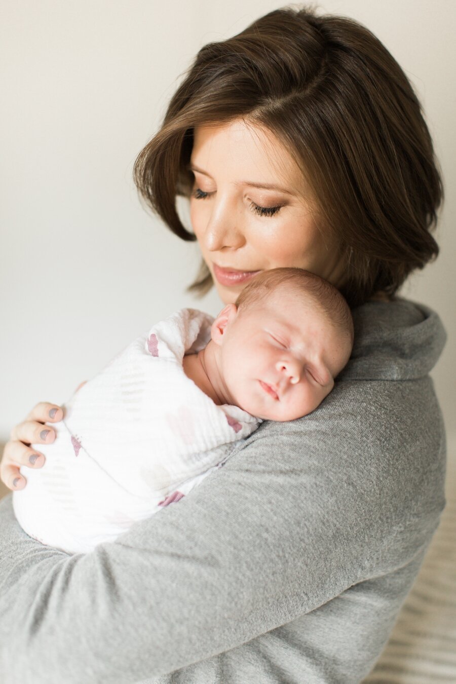 mom holding her newborn baby 