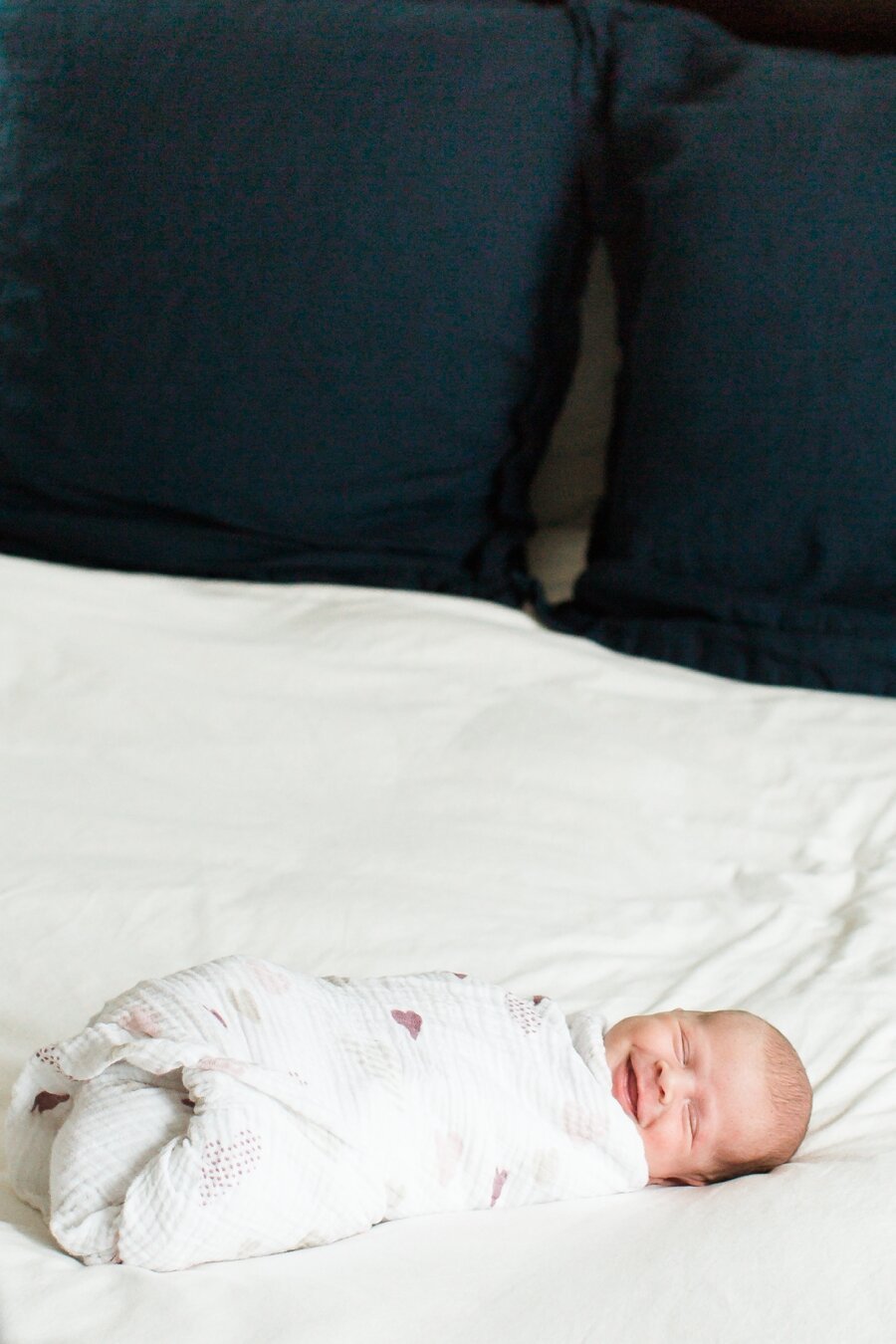 newborn smiles at camera