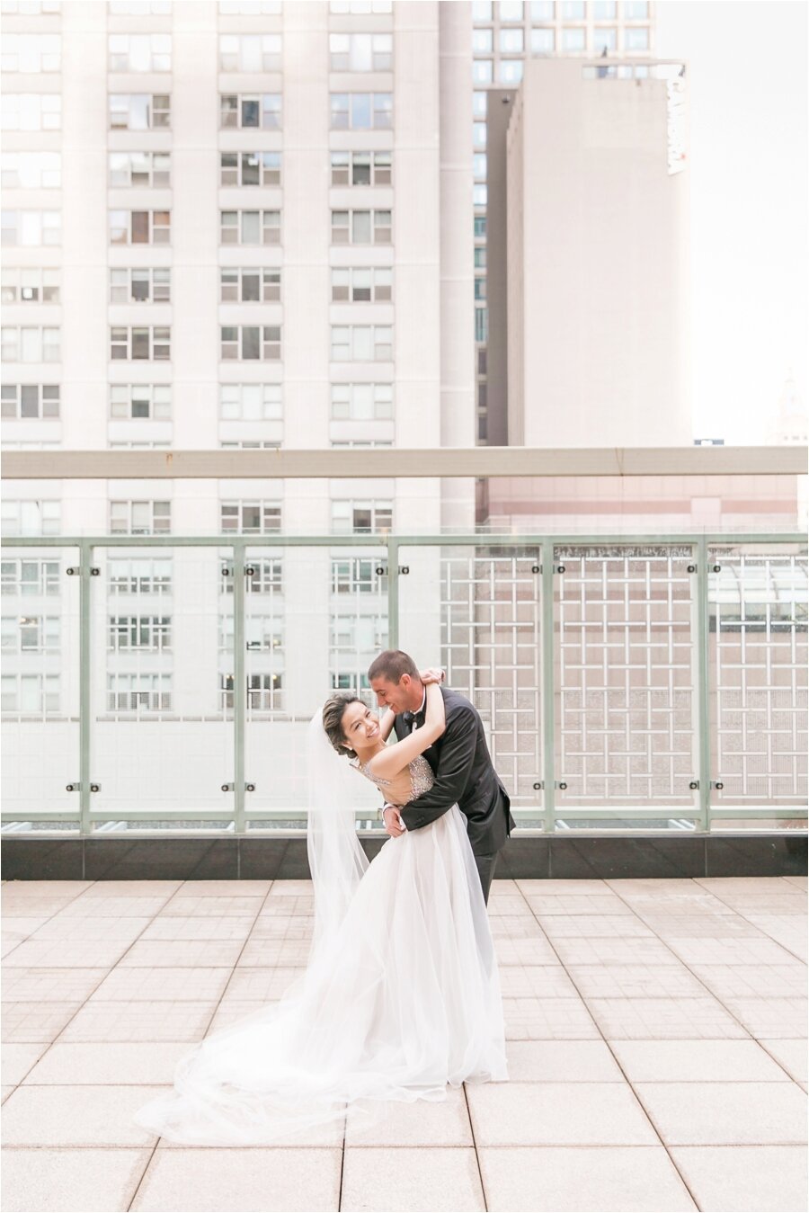Bride and groom poses on rooftop at The Peninsula Hotel Chicago 