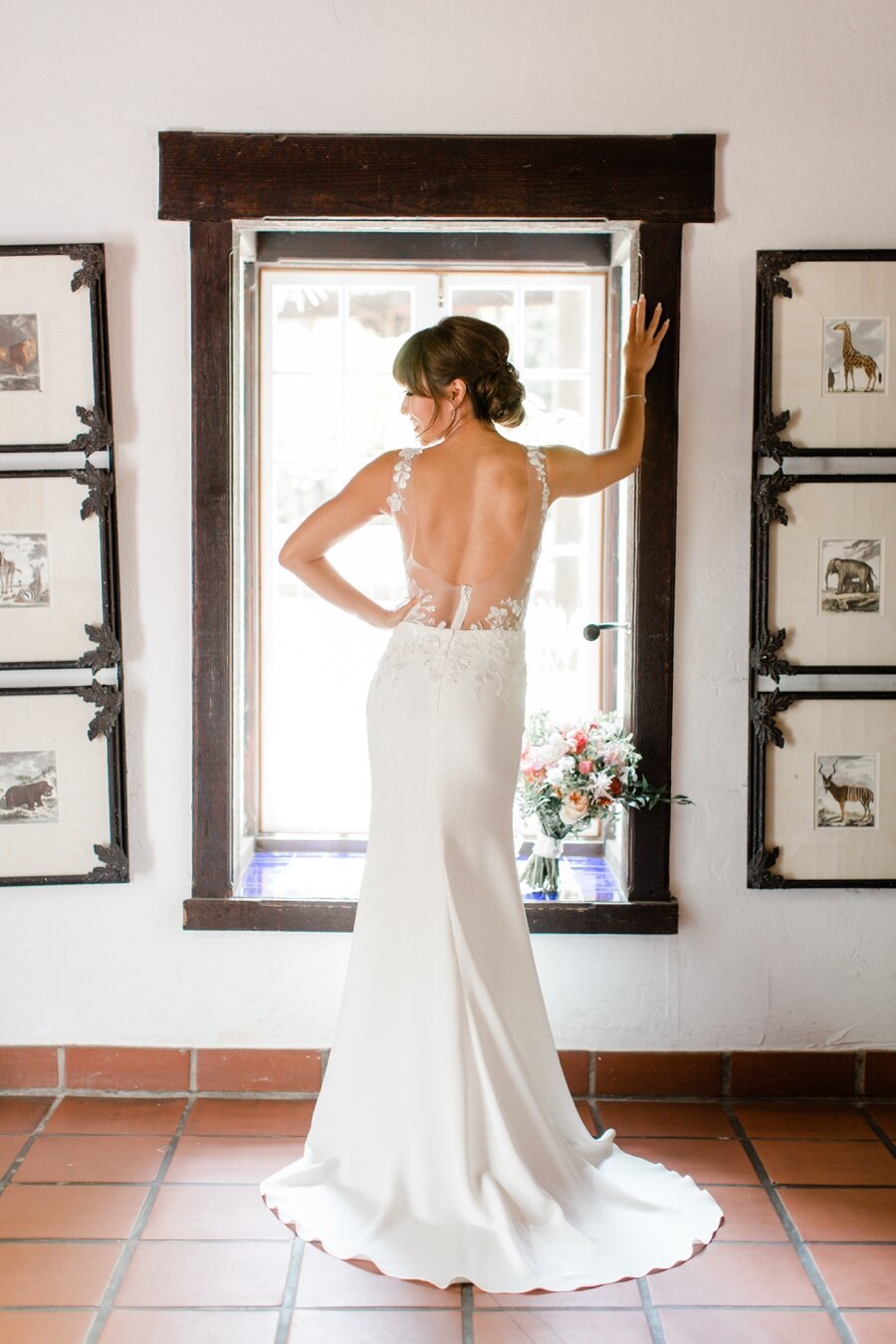 bride poses by a window 