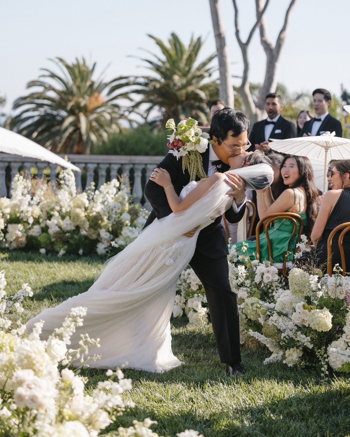 Overlooking the endless blue of the Pacific, these two said &ldquo;I do&rdquo; surrounded by the European charm of @villasanctimalibu . 

Melody stunned in a sheer, beaded @nettabenshabu.official gown that shimmered in the ocean breeze, while moody g