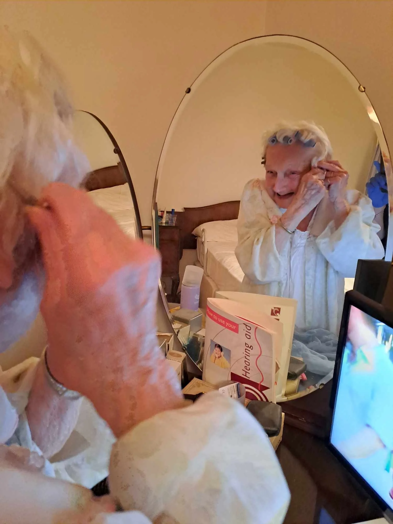 Older lady putting roller in her hair.