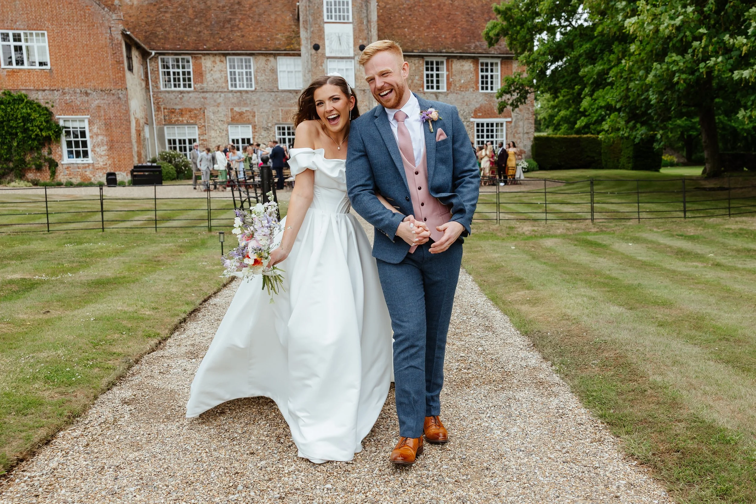 Newly married couple walking back down the aisle during outdoor wedding