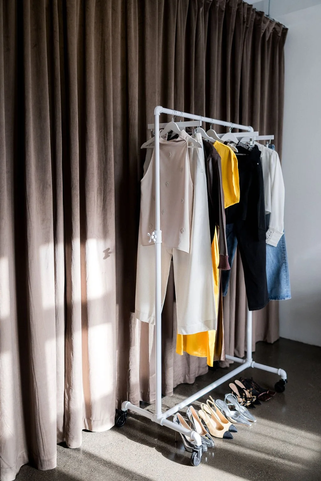A clothing rack styled and curated by Kathryn Snow, personal stylist, fashion expert, and wardrobe consultant in Grand Rapids, Michigan