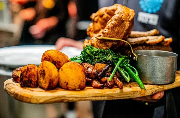 lake view garden bar - Sunday beef roast dinner on wooden table with sides and real ale. restaurant and pub food done properly