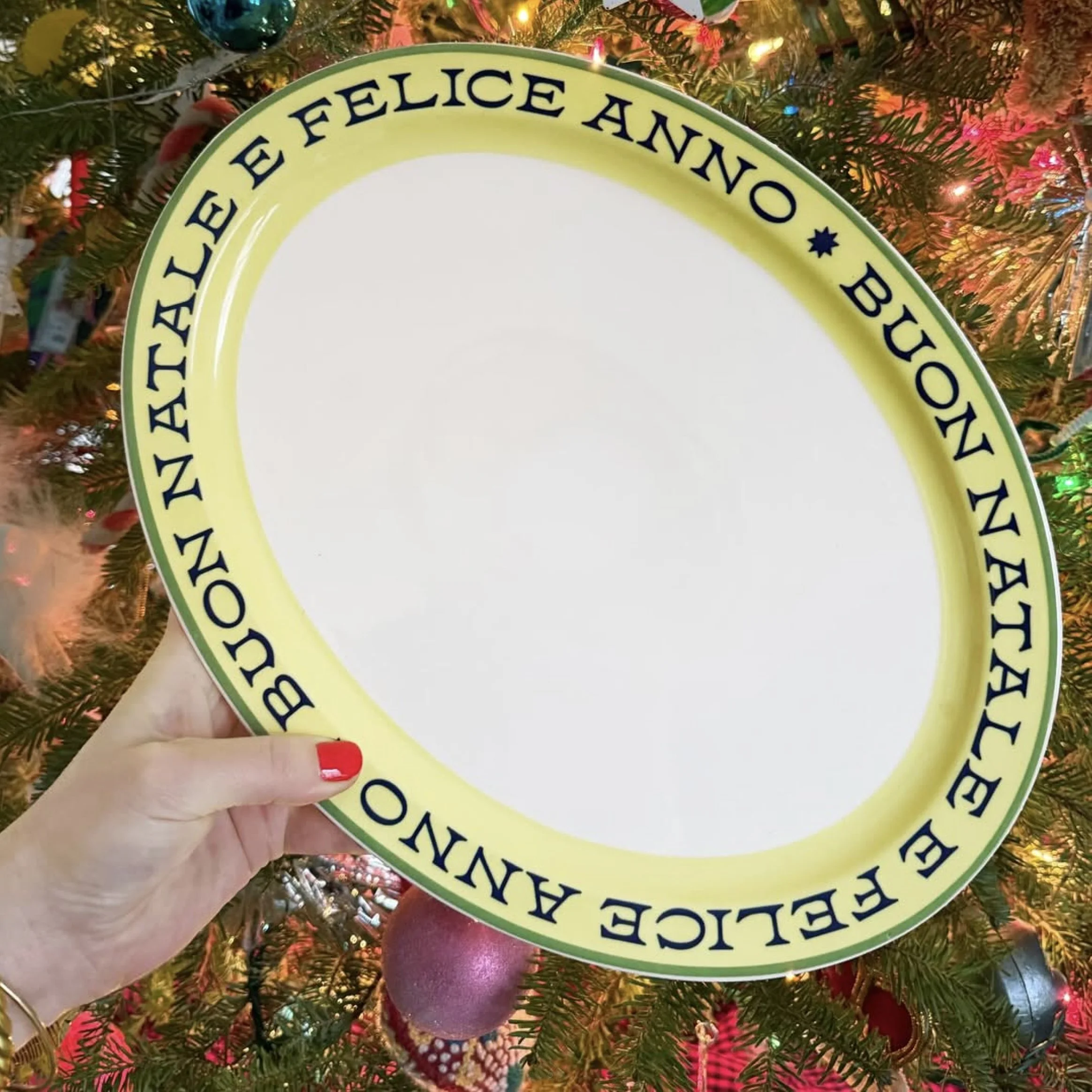 Oval platter trimmed with retro typography that says "Felice Anno" and "Buon Natale"  - italian for Happy New Year and Merry Christmas.
