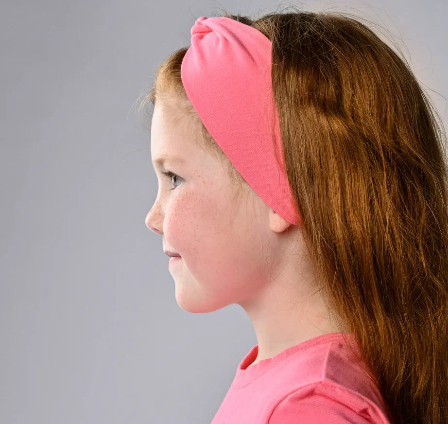 Child wearing a protective headband after otoplasty — ear pinning recovery with Dr. Sturgill in Carmel, Indiana