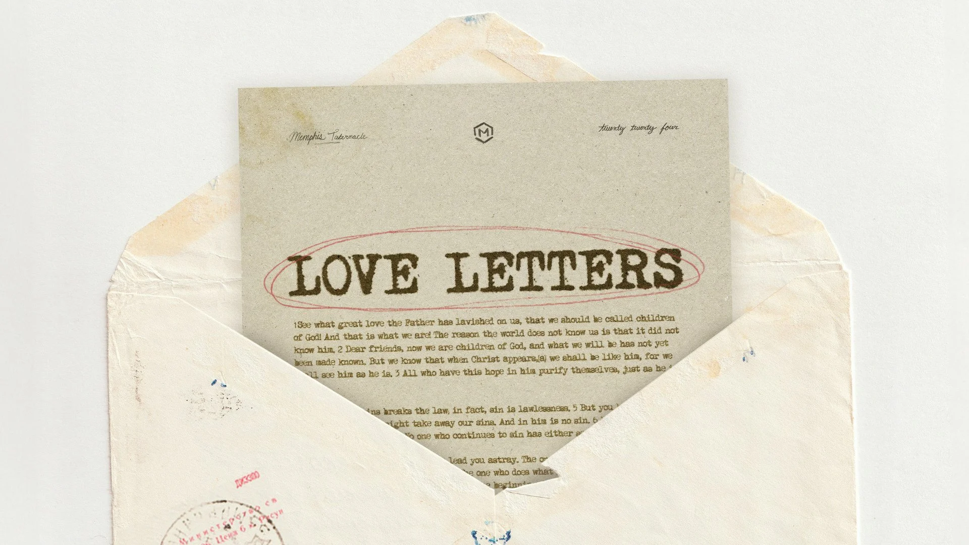 A love letter partially visible inside an off-white envelope on a white surface, with the word 'LOVE LETTERS' prominently printed on the letter.