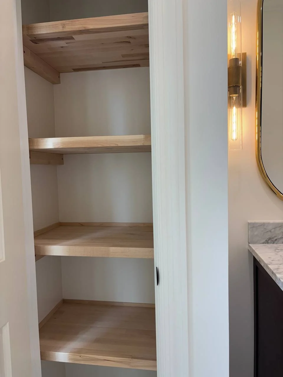 Custom built-in shelving inside bathroom linen closet of master suite addition in Chattanooga TN.