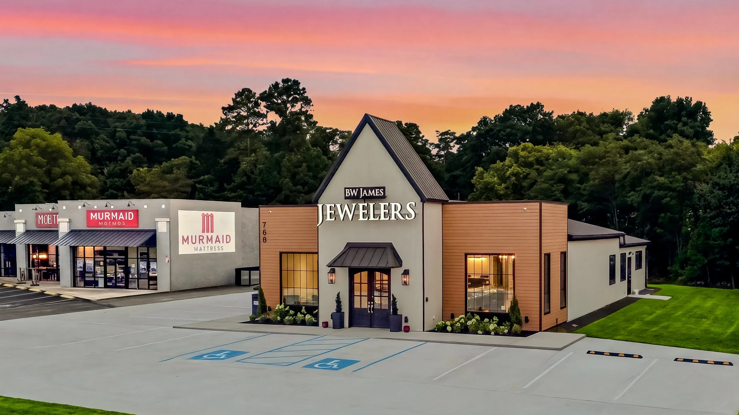 Sleek, modern exterior of BW James Jewelers in Cleveland, TN, featuring composite cladding, natural travertine, expansive storefront windows, and a custom commercial design by VMH Construction.