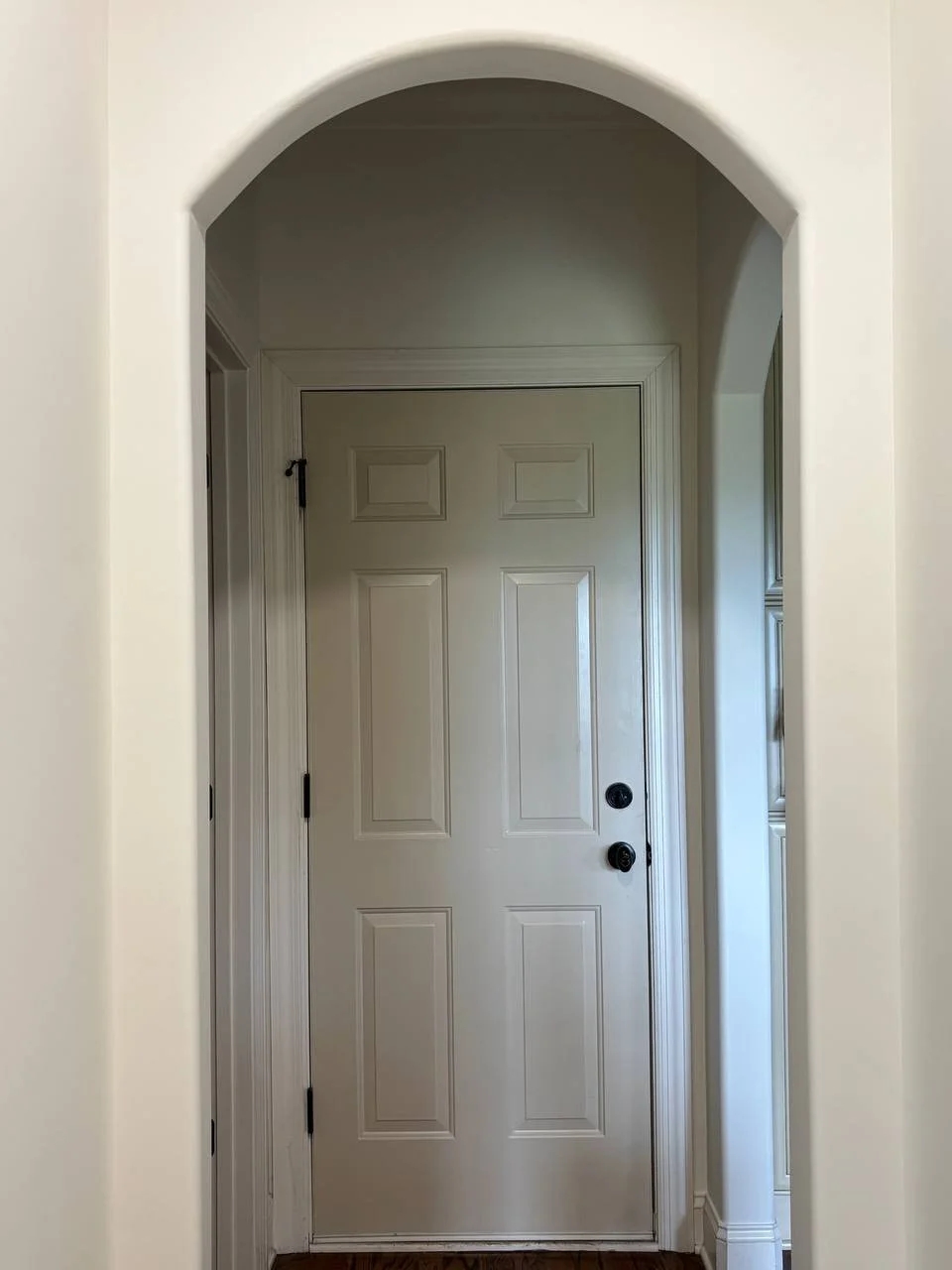 Interior view of a custom home addition in Chattanooga TN featuring an arched doorway and painted trim details.