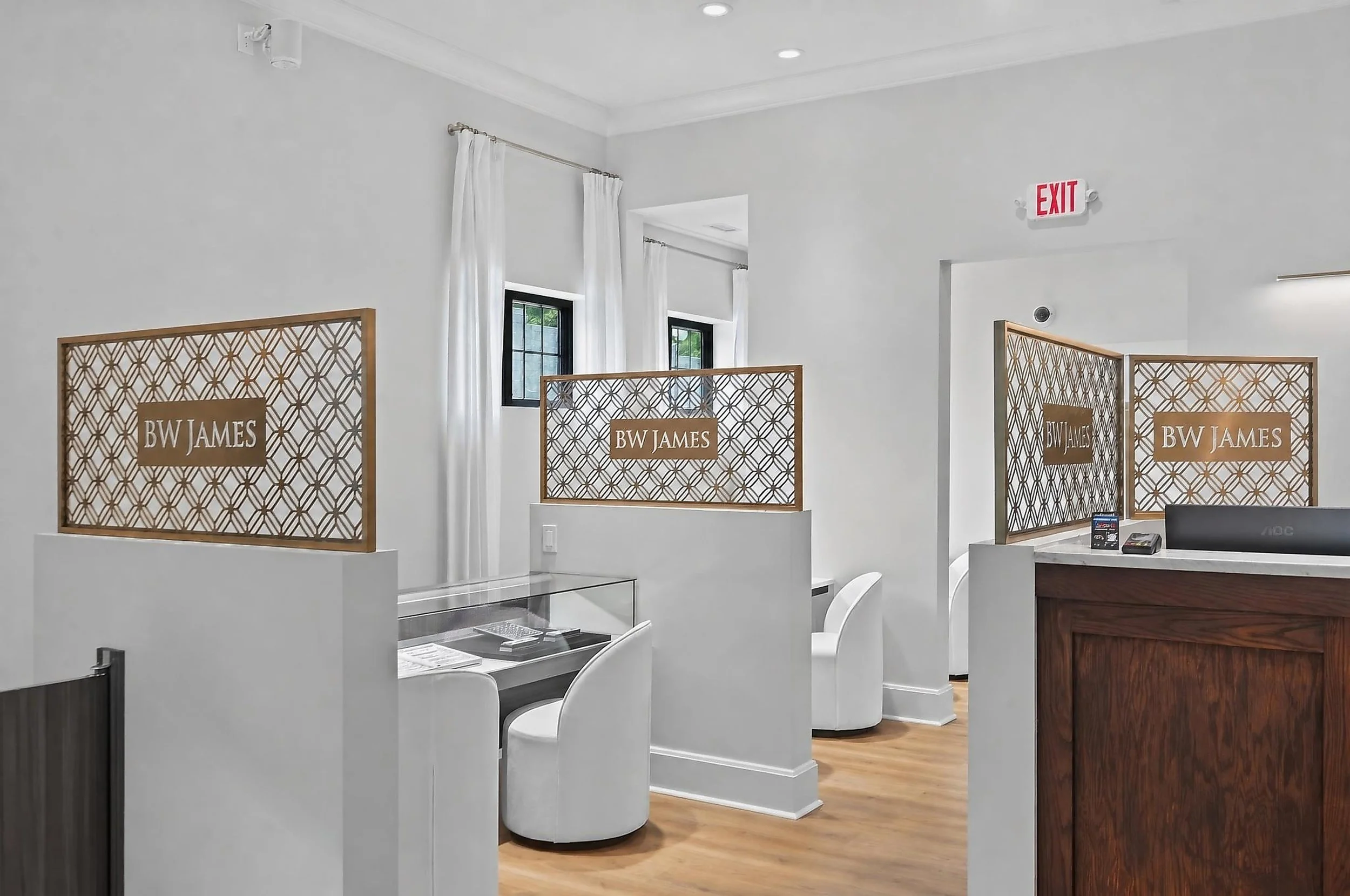 Private jewelry consultation areas at BW James Jewelers in Cleveland, TN, featuring custom decorative privacy screens, glass display cases, comfortable seating, and refined wood finishes, designed and built by local commercial builder VMH Constructio