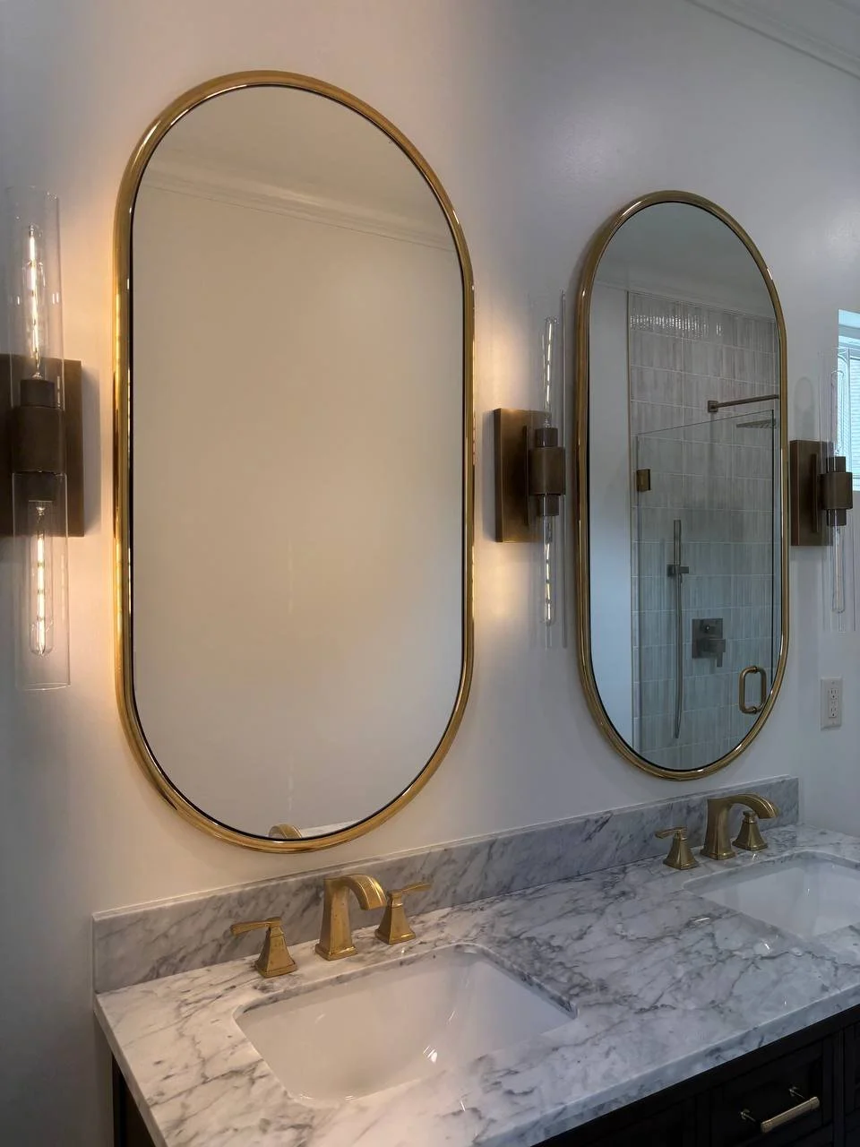 Luxury bathroom vanity with marble countertop, dual sinks, and gold fixtures in Chattanooga TN master suite addition.