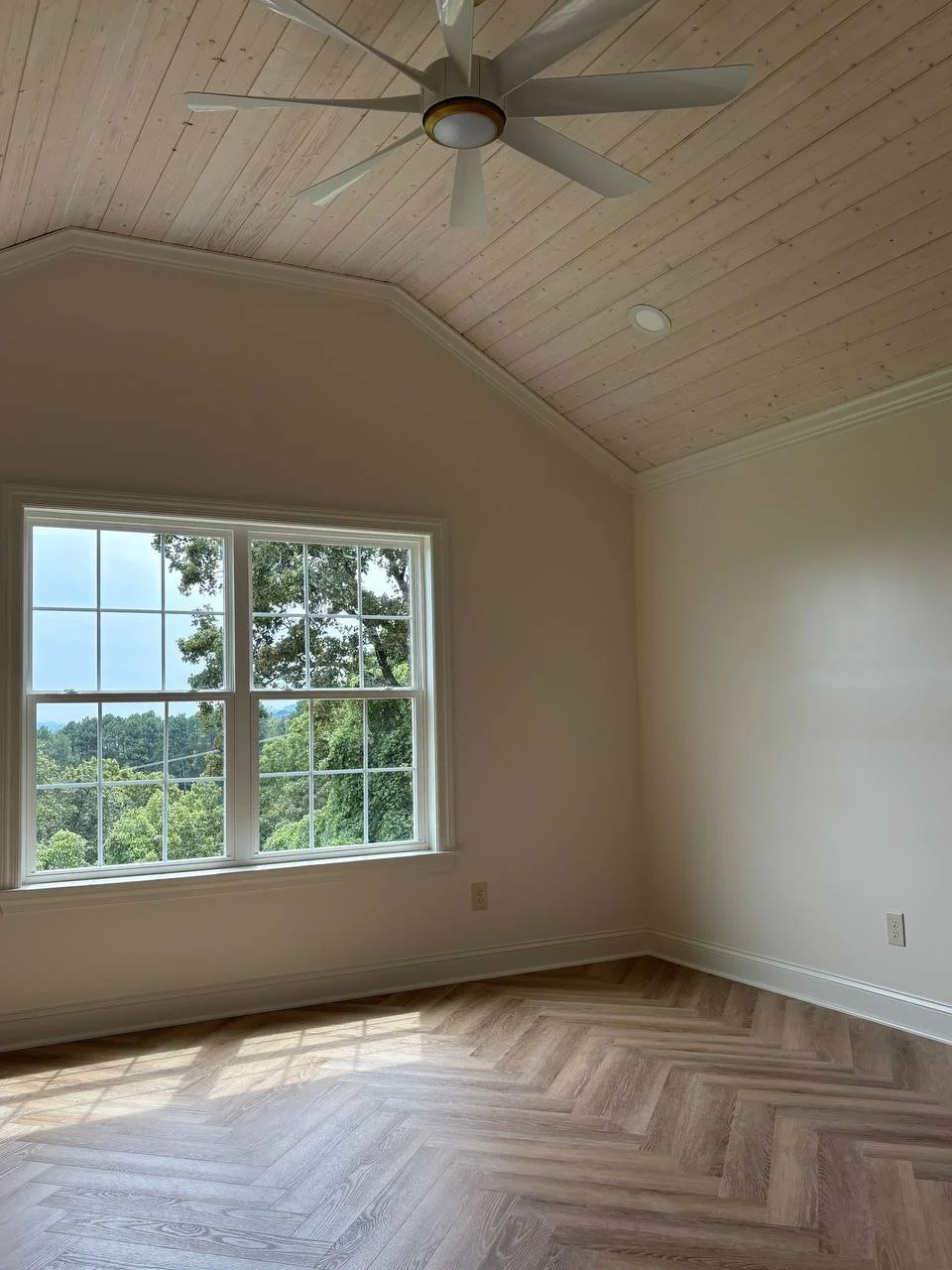 Master suite addition with whitewashed tongue-and-groove ceiling and large window in Chattanooga TN home.