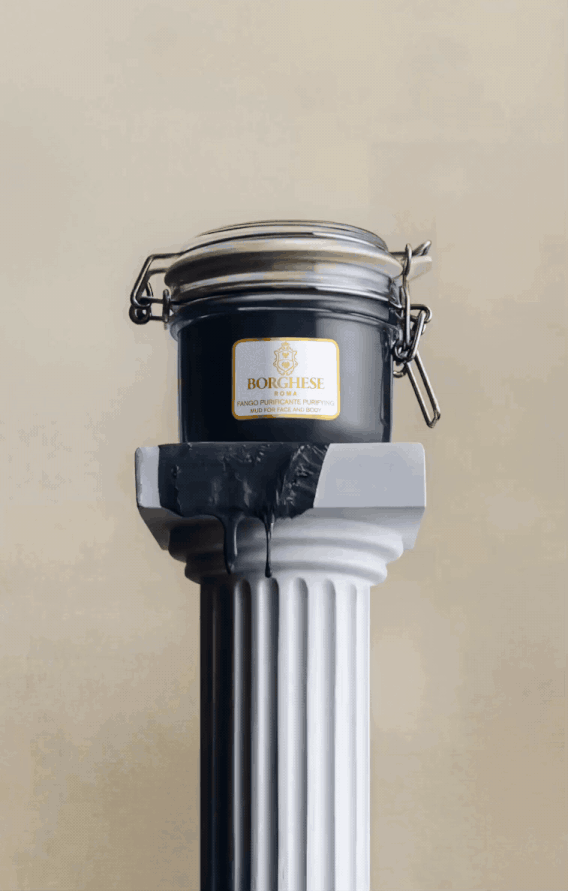 A black jar of Borghese Fango Purifying Mud is placed on a white classical-style column.